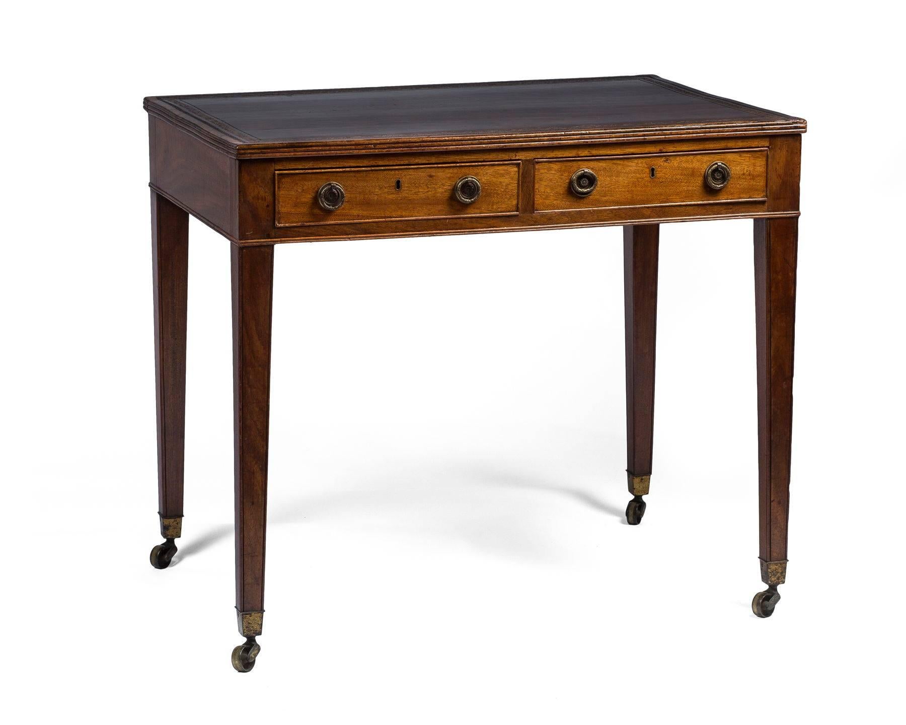 The rectangular top inset with a tooled leather, above two short drawers opposed by two dummy drawers, on square tapering legs ending in casters, one drawer bearing a paper label for Stair & Co., 59 East 57th Street New York, resellers of 