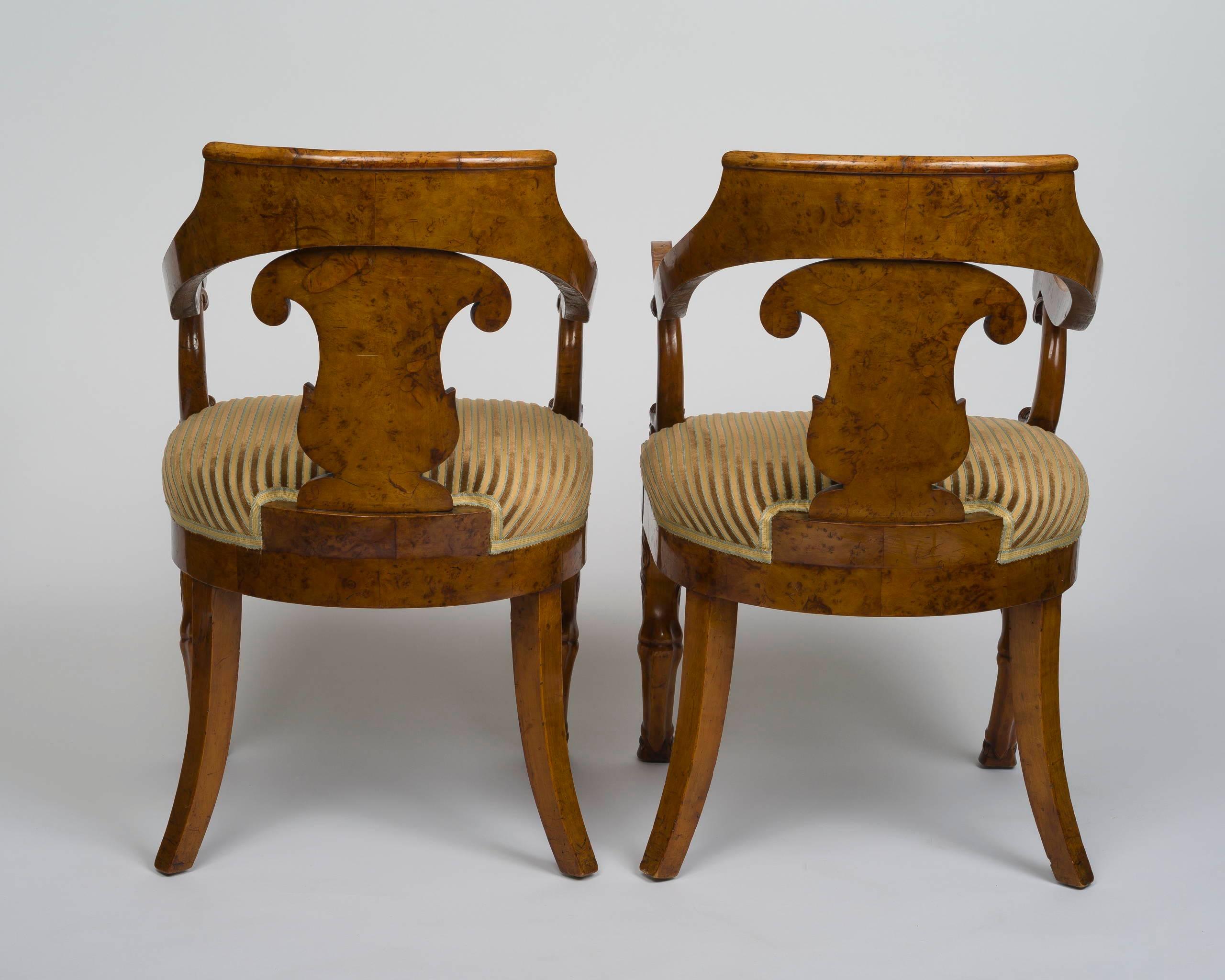 The curved pierced back with a palmette-inlaid shaped splat terminating in dolphin supports raised on an upholstered seat, on front carved joined hairy animal legs (pieds de bîches) and hoof feet and back sabre legs; stamped: JACOB FRERES RUE MESLEE