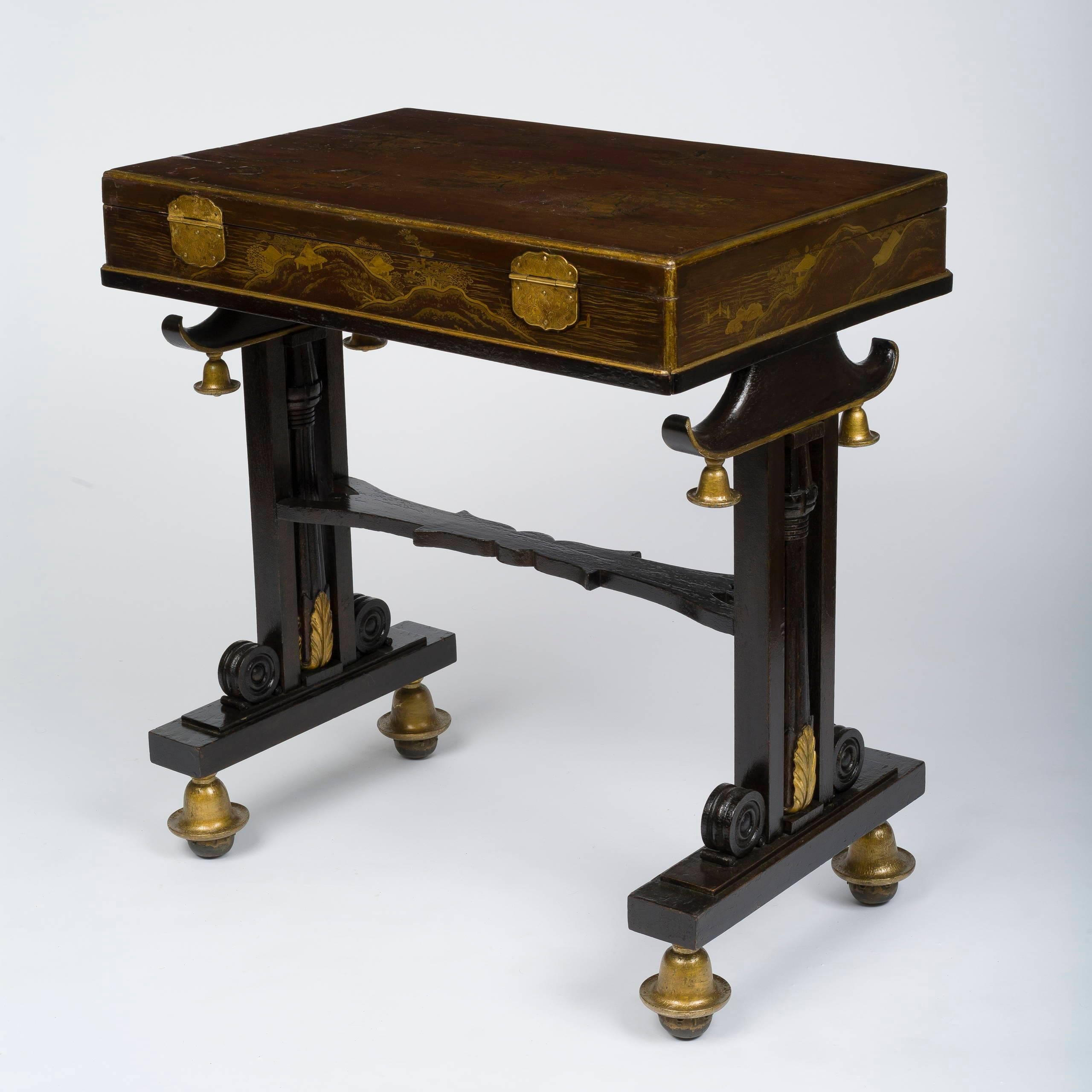 The Japanese lacquered box hinged to open to an adjustable fabric-inset writing surface, inset in a Stand with twin supports in the Chinese taste. This exceptional desk is very much evocative of the exotic style made fashionable by the Royal