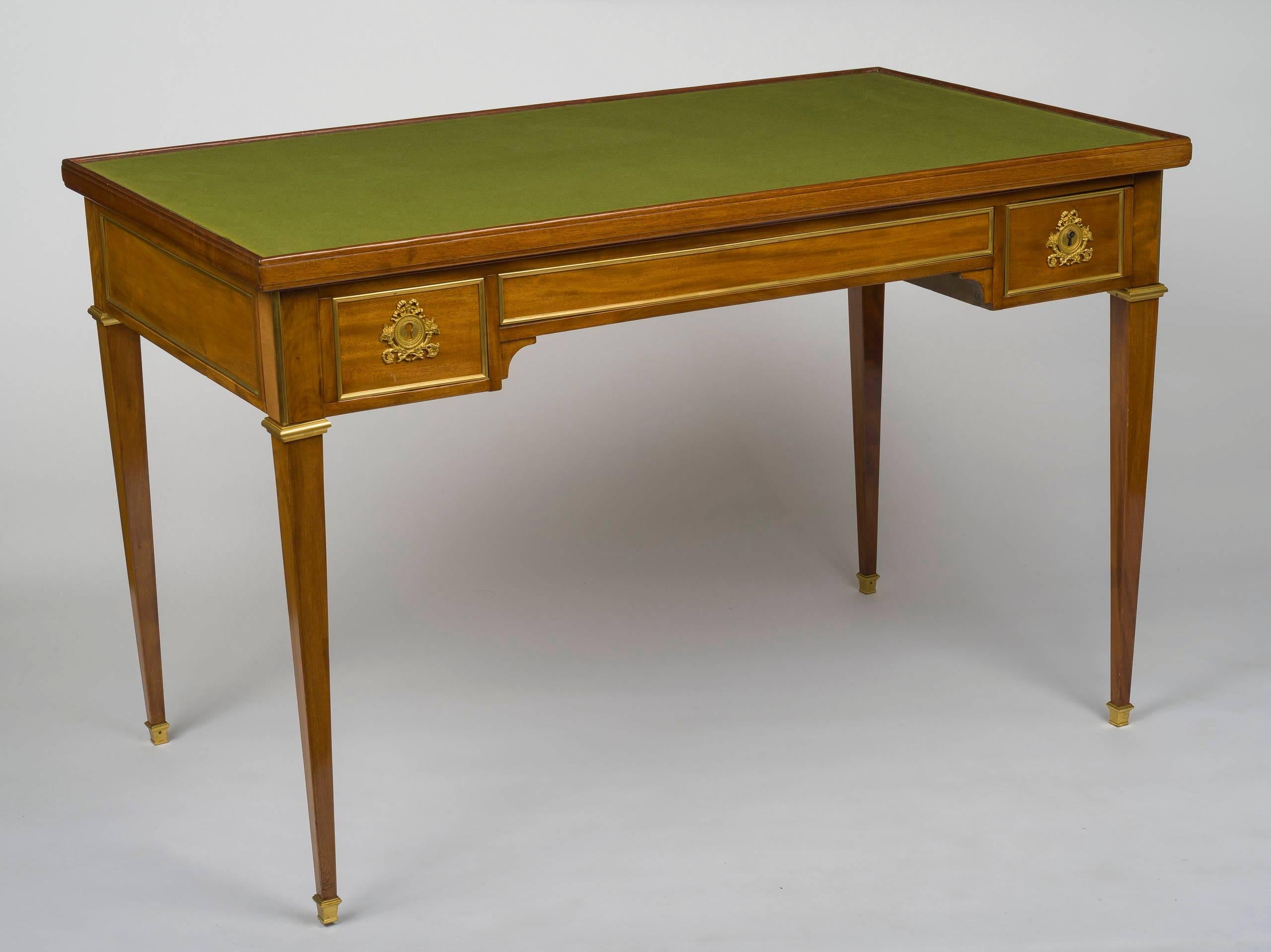 Of rectangular form, the removable top with an inlaid chessboard reversing to a green felt playing surface, the case with an inset tric trac interior and one dummy and one real drawer to each long side, raised on tapering square legs ending in