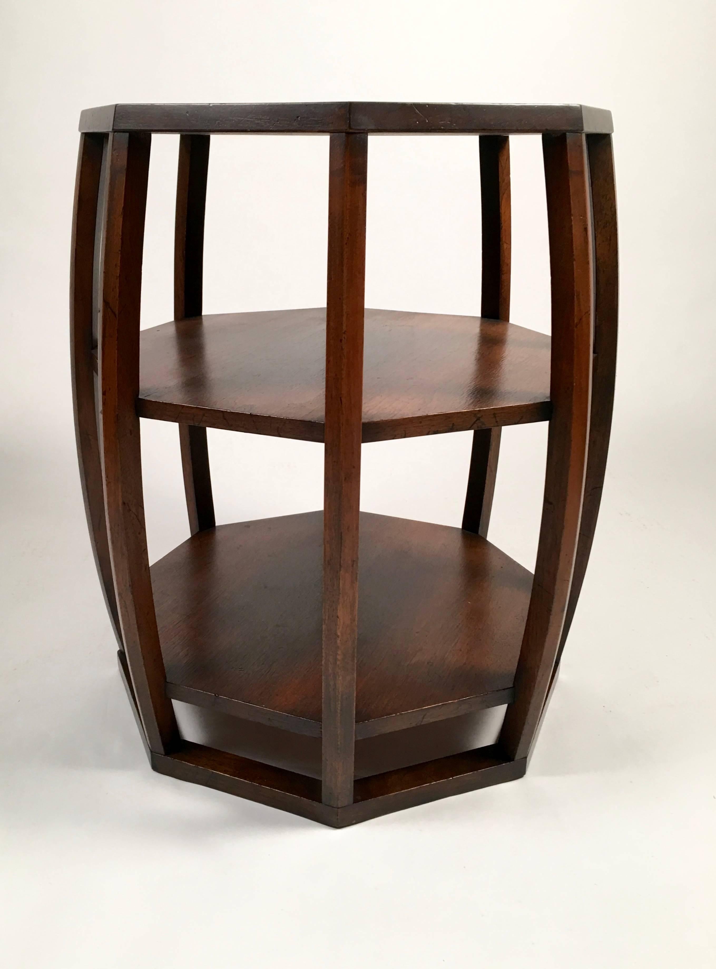 A well-made Asian inspired Mid-Century Modern occasional table in 'antique bronze' stained oak, of octagonal barrel-form, the open sides revealing two interior shelves, retaining its original Widdicomb Furniture Company label.

Measures: Height:
