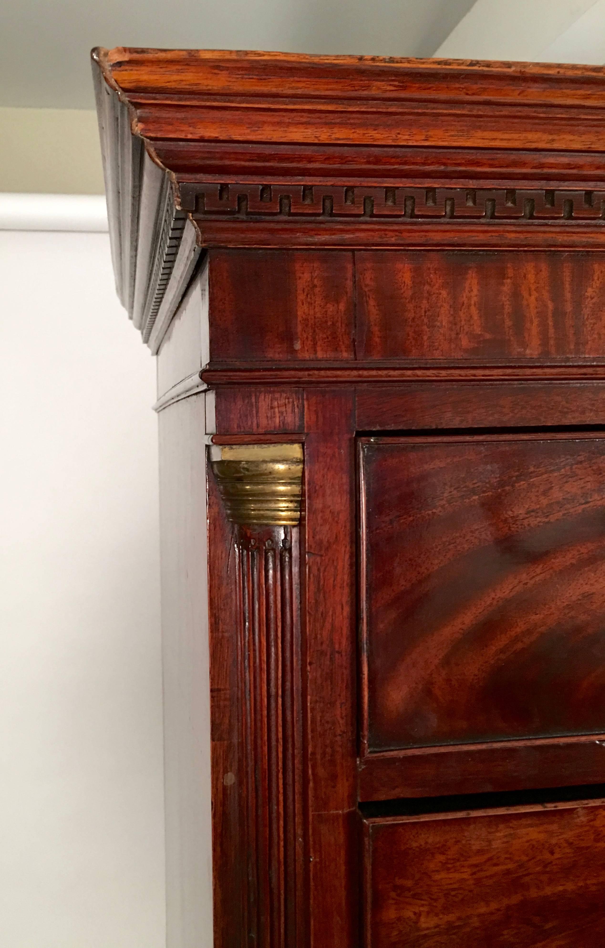 A fine quality George III chest of drawers, or chest  on chest in beautiful, richly figured mahogany, in two sections, the crown cornice over a band of dentil  Greek key molding above two short drawers , over three long drawers on the upper section,