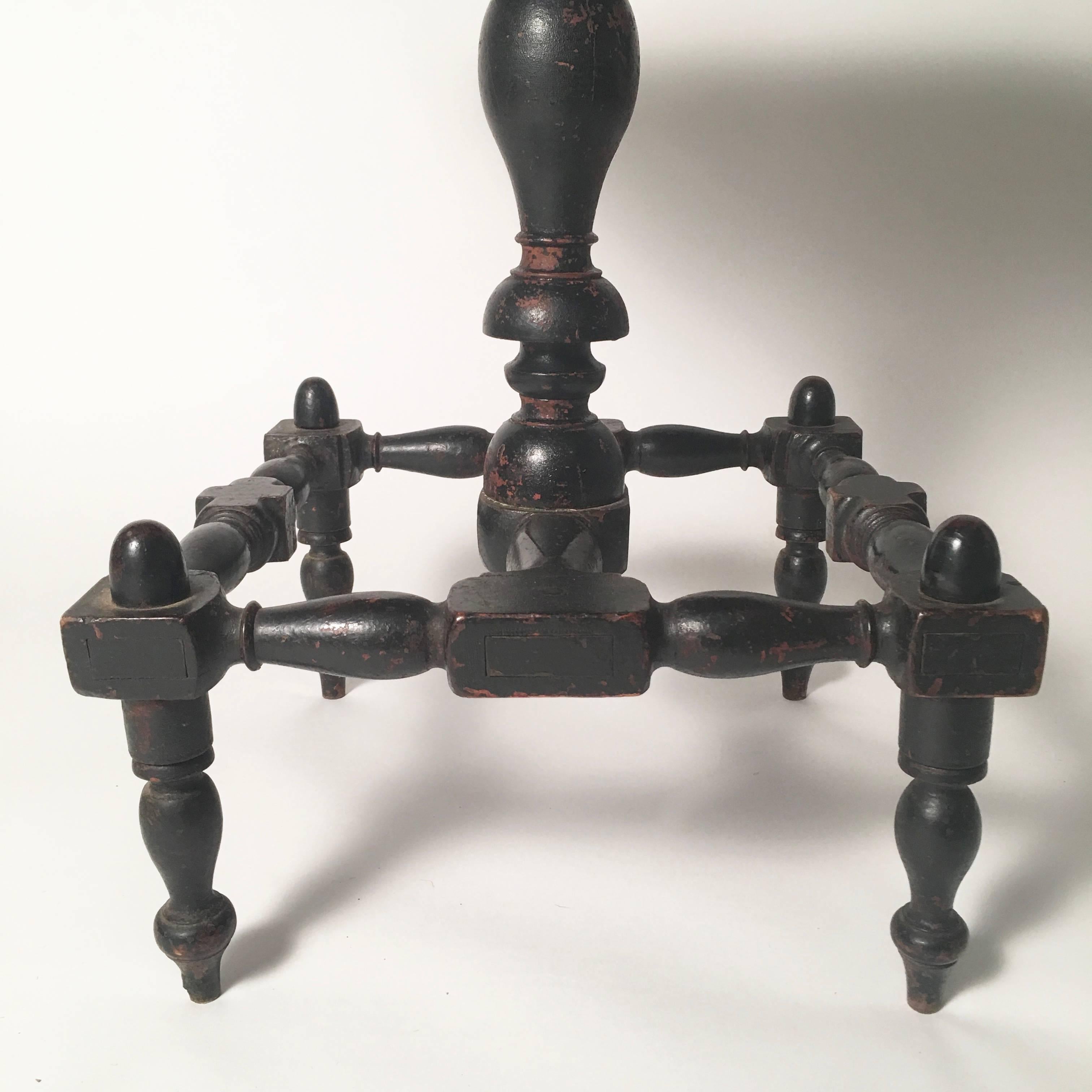 An unusual, sculptural early 19th century American occasional table, in ebonized pine and tiger maple, New England, circa 1820-1830, the square top with ovolu corners over a drawer mounted on the underside, threaded onto a vase- and ring-turned post