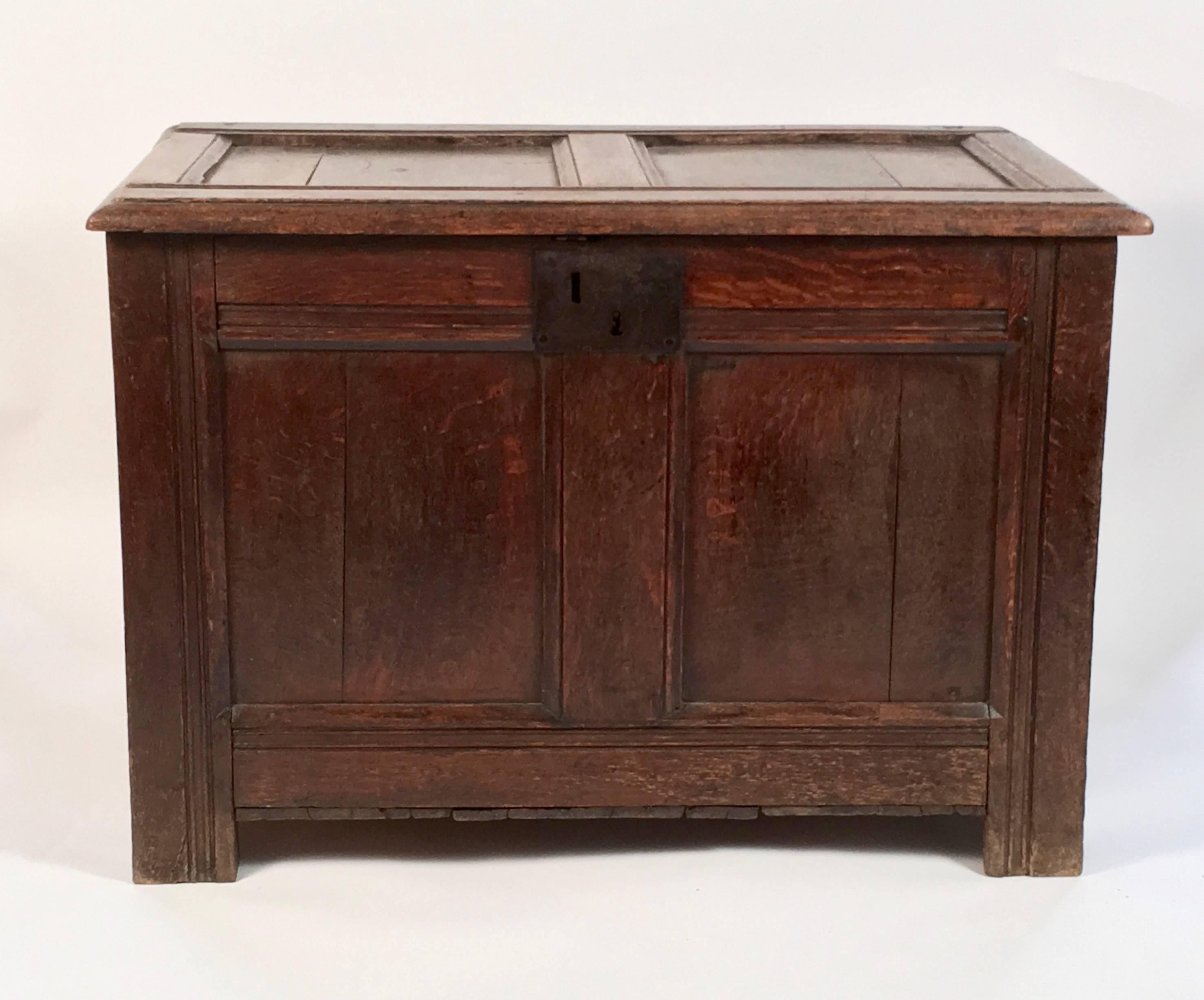 A wonderfully small sized English 17th century paneled oak chest, of rectangular form, the paneled lift top opening to provide storage space. Rich color, great character. Perfect size for a coffee table or at the end of a bed.