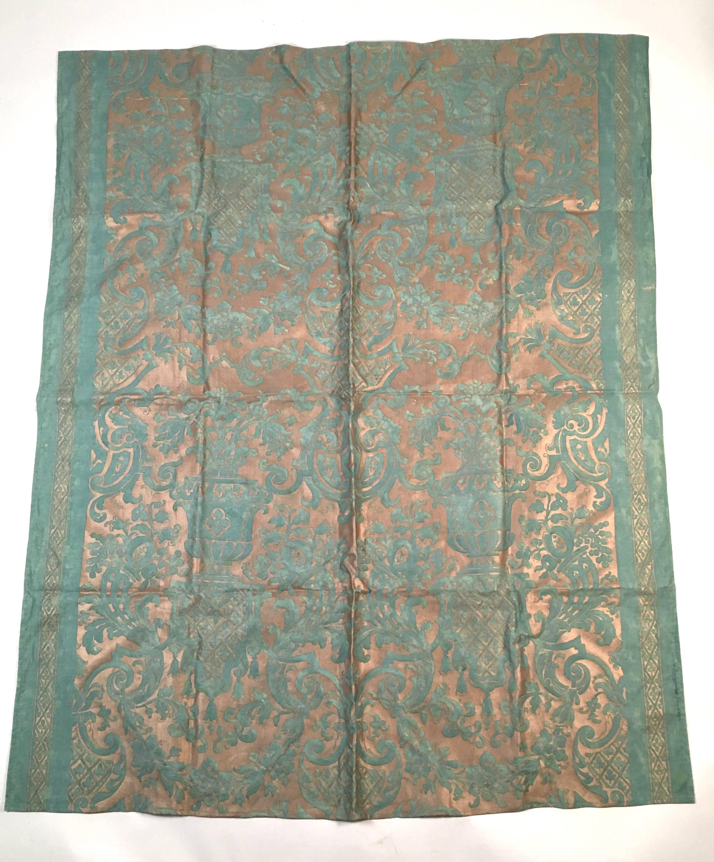 A fine large panel of original vintage Fortuny fabric in jade green and gold in the Carnavalet pattern, which features classical urns with sprays of flowers issuing forth over Baroque style baldachins with bell flowers hanging from them. Signed