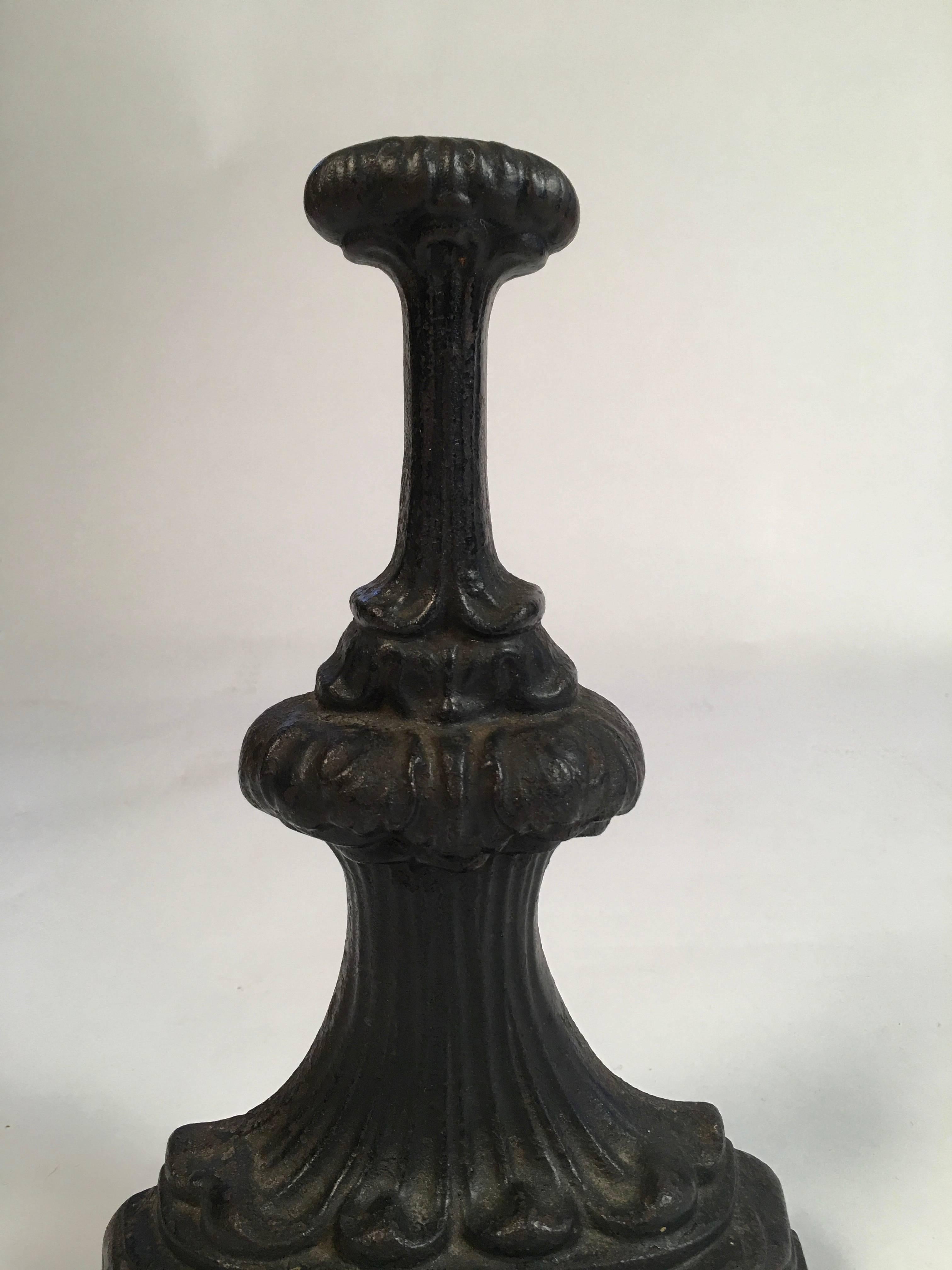 A Victorian cast iron door stop, with D-shaped base and sculptural top, decorated with acanthus, lotus and banded laurel leaf decoration, circa 1840-1860.