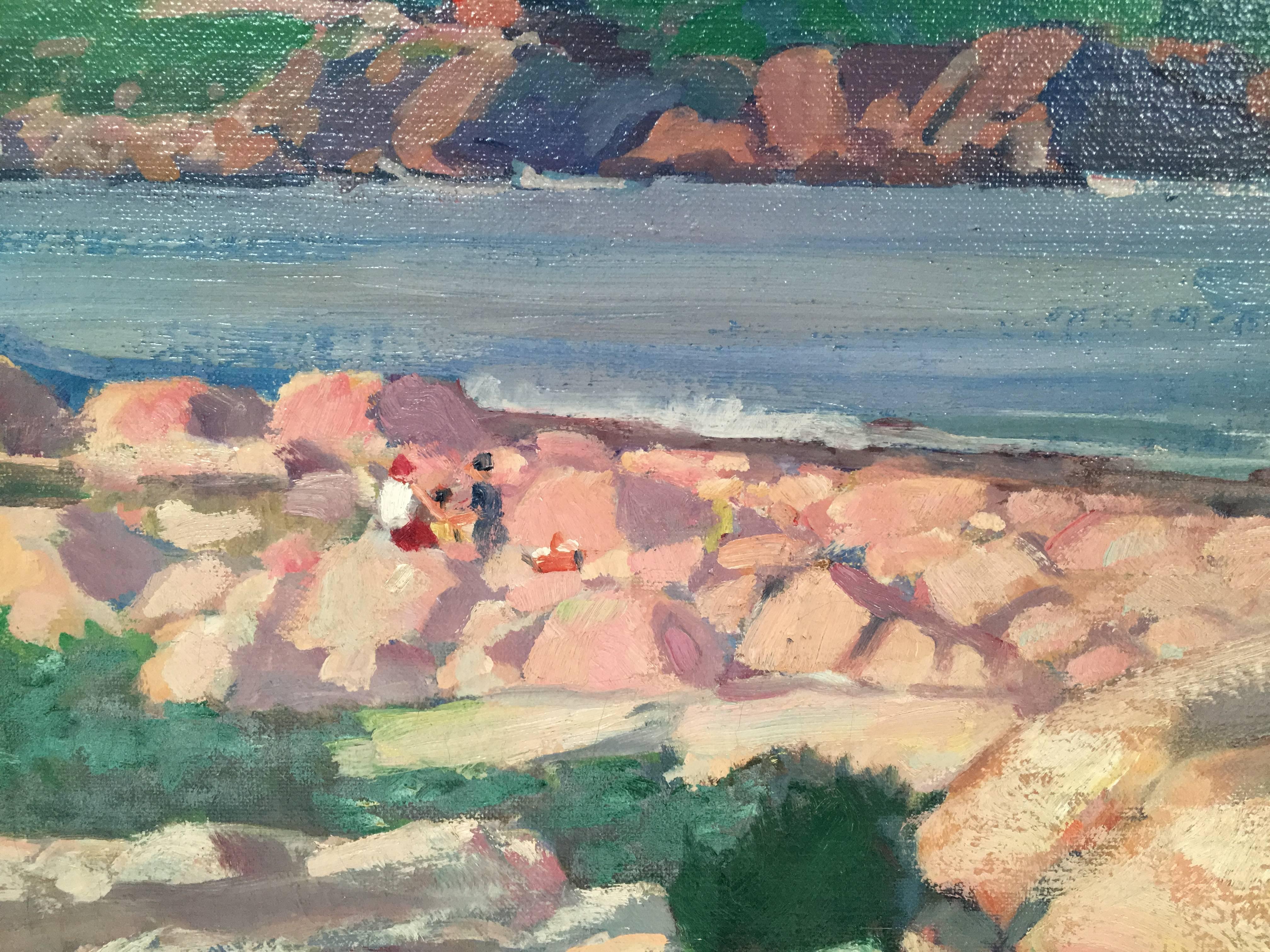 An oil on canvas painting by Donald Blagge Barton (1903-1990) depicting the rocky coast of Gloucester, Massachusetts, likely the area known as Bass Rocks, on a sunny day, with waves gently crashing and picnickers on the rocks, enjoying the view.