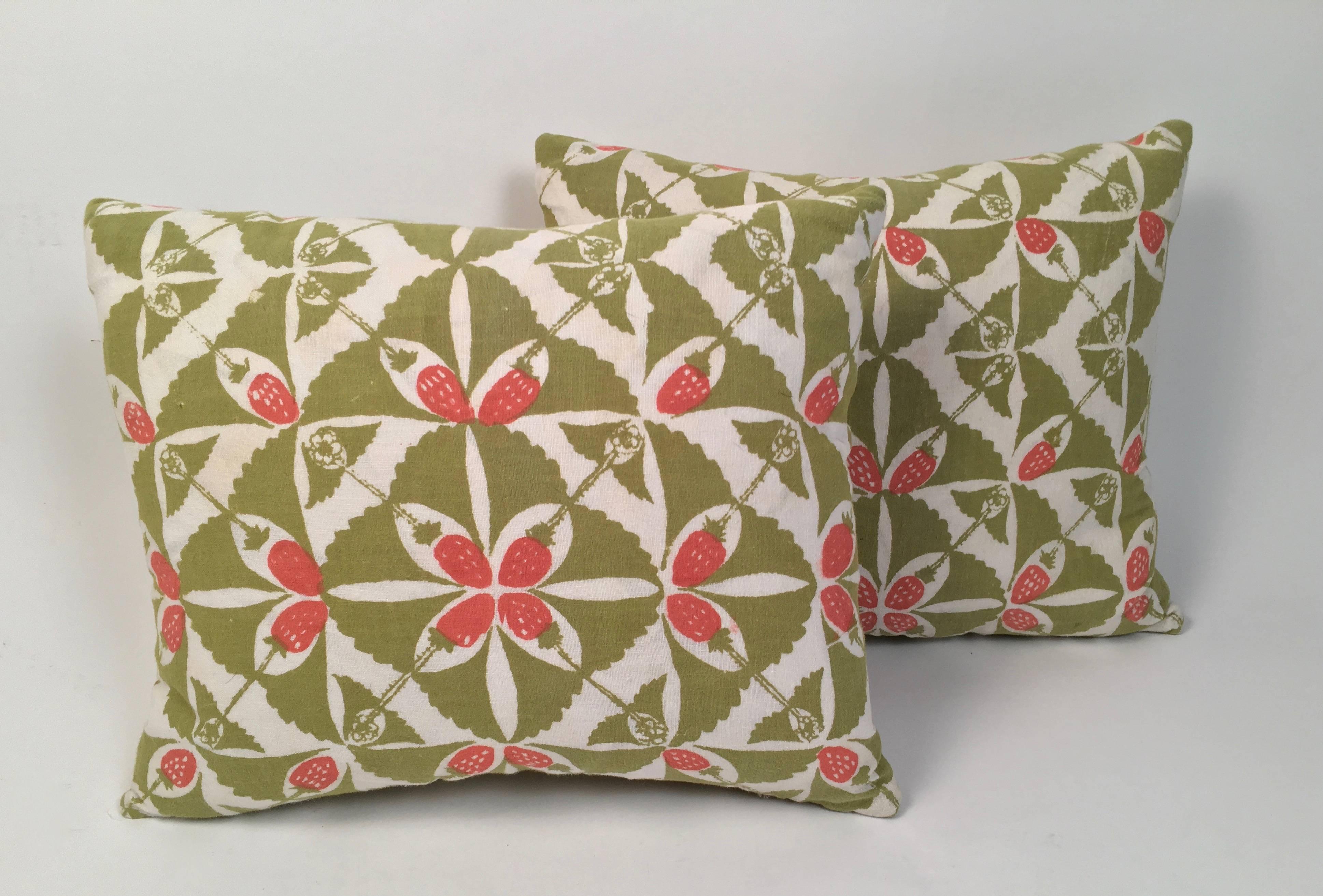 An original vintage hand block printed pillow in the Strawberry Patch pattern, by Peggy Norton, for the Folly Cove Designers, circa 1964, in olive green and pink on cream cotton, hand-sewn, down filled and backed with corresponding green cotton