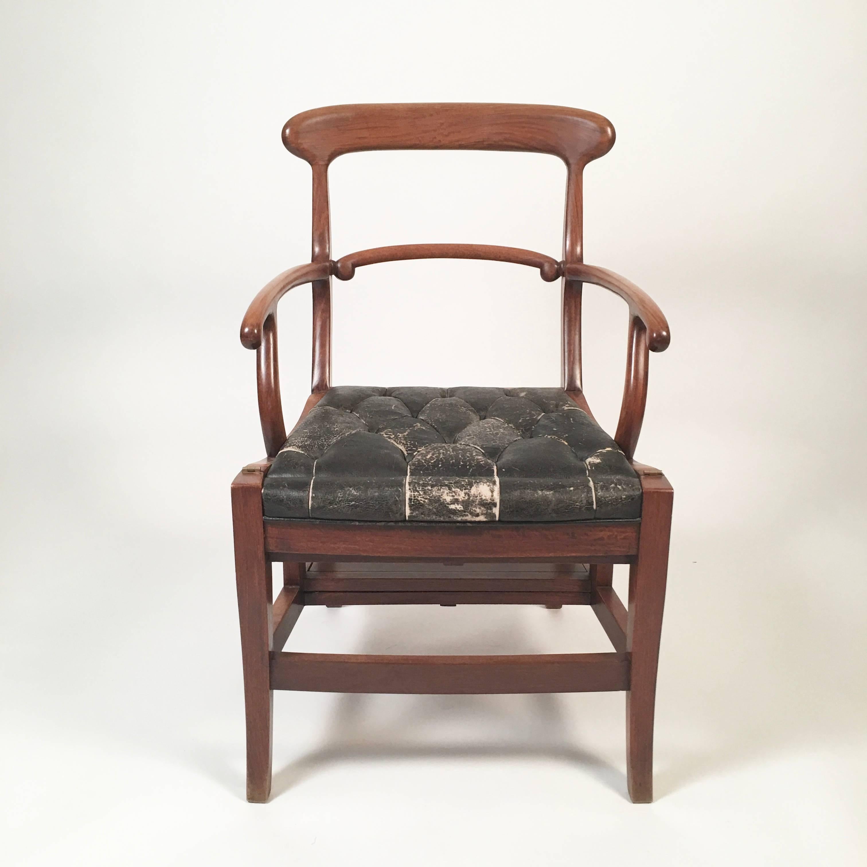 A beautifully made chair which converts into library steps, also known as a metamorphic chair, in solid teak with a tufted leather seat. This example of Dual use furniture, after an English Regency example, dates to, circa 1910 and is Chinese