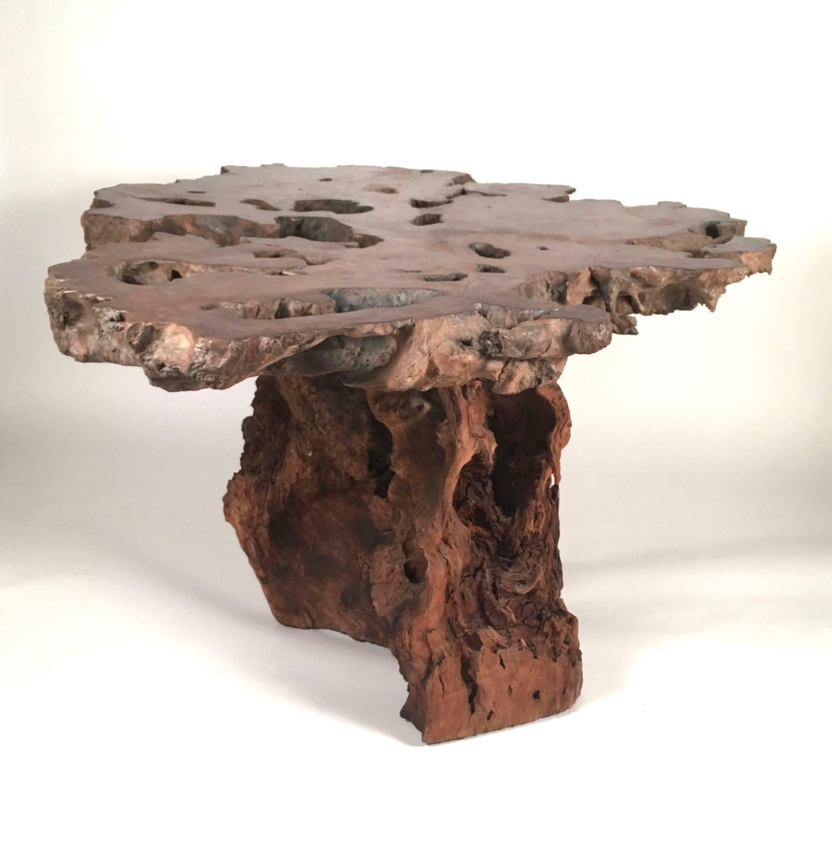 A spectacular, monumental  California Redwood live edge table. With its richly figured top, retaining its understated dry finish and conforming sculptural trunk base, this table makes an impressive statement floating as a centre table in an entrance