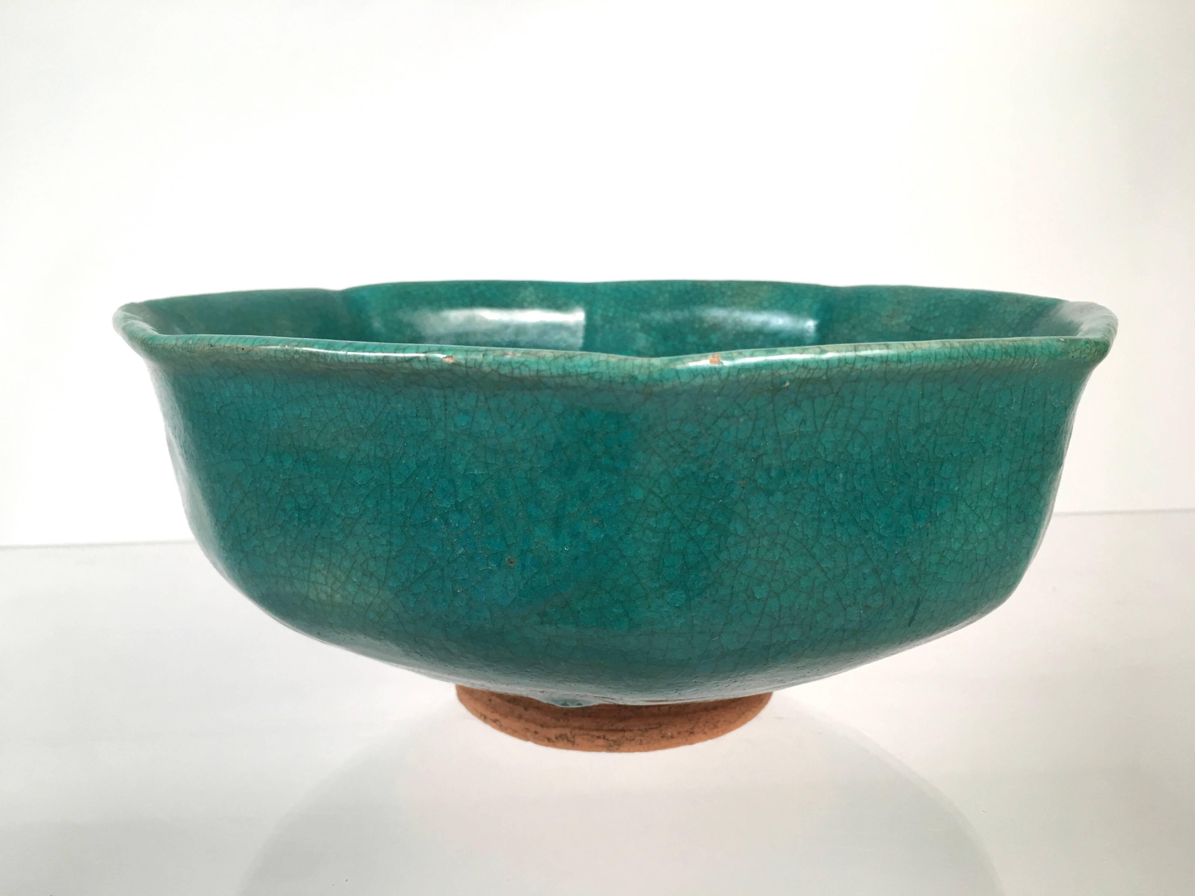 A turquoise glazed art pottery bowl by Leon Volkmar for Durant Kilns, of circular form, with an octagonal rim which tapers down to a circular unglazed foot ring, the bottom of which is incised Durant and 1915, the year of manufacture. The turquoise