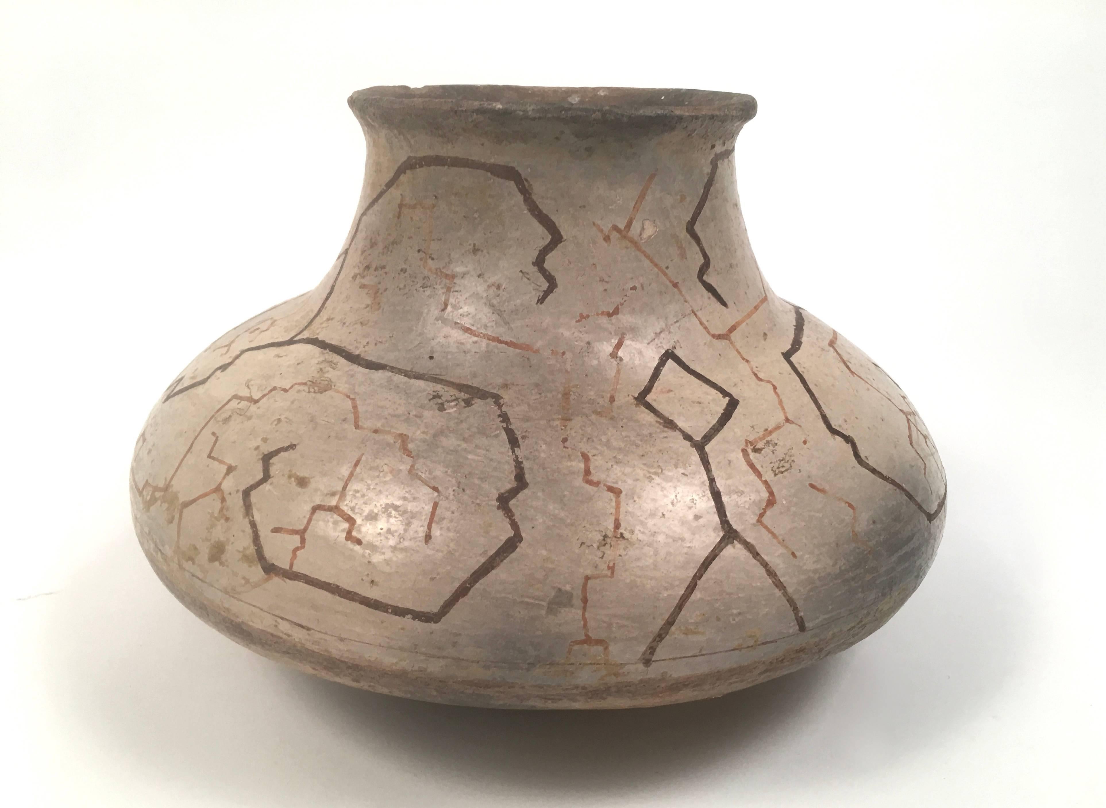 A hand painted pottery vase by the Shipibo people of Peru, circa 1900, in earthenware with hand painted geometric designs, using natural pigments, which represent constellations and various planets. Wonderful dry surface and patina. 

