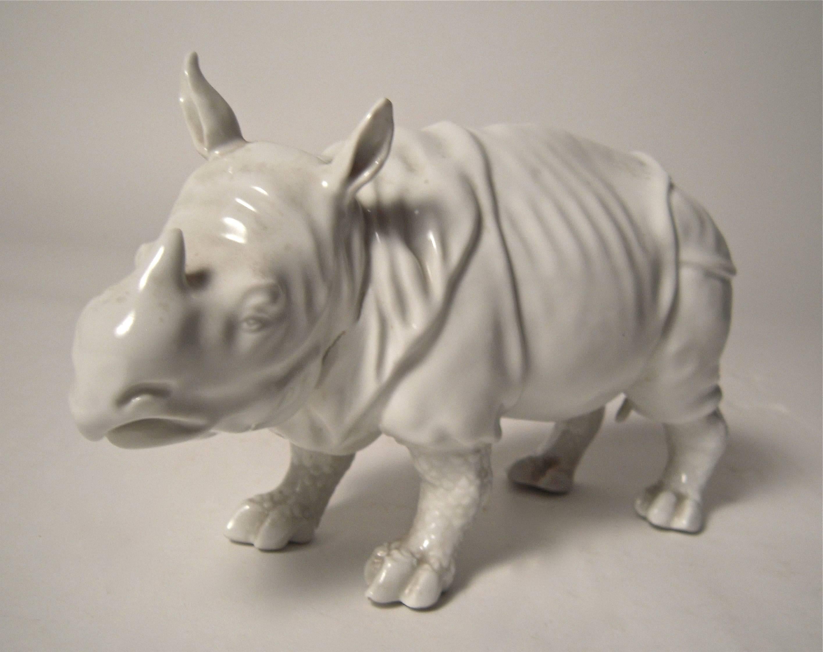 A pair of naturalistically modeled blanc de Chine porcelain rhinoceros sculptures, probably German, circa 1890-1910.
