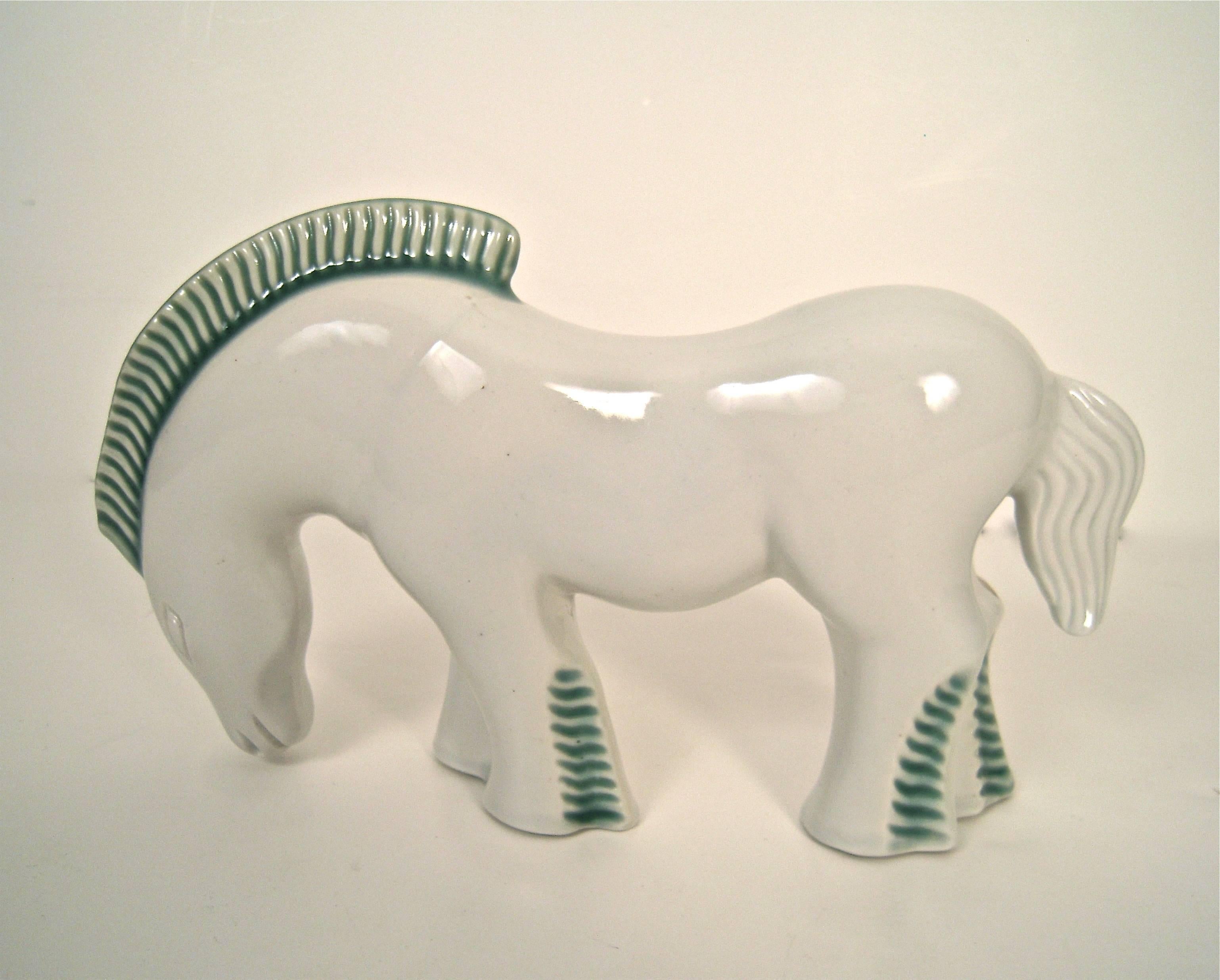 A stylish 1930s Japanese Art Deco pottery figure of a horse, made for the European and American markets, in white glazed earthenware with forest green incised main and legs. Signed with printed 'Kent Art Ware' mark on the underside of the horse's