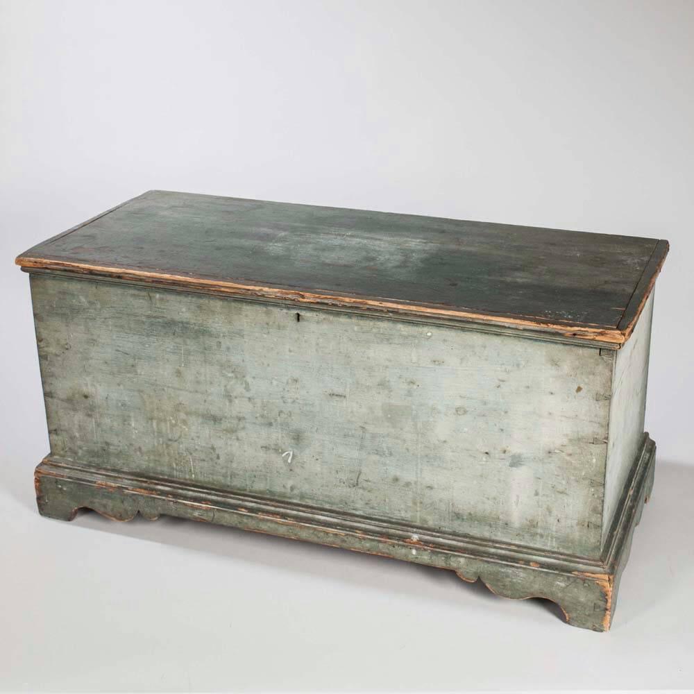 A late 18th century New England six board blanket chest, retaining its original, beautiful pale blue painted surface, of rectangular form, with molded lift top, finely detailed dovetail joints and well proportioned bracket feet. Beautiful form,