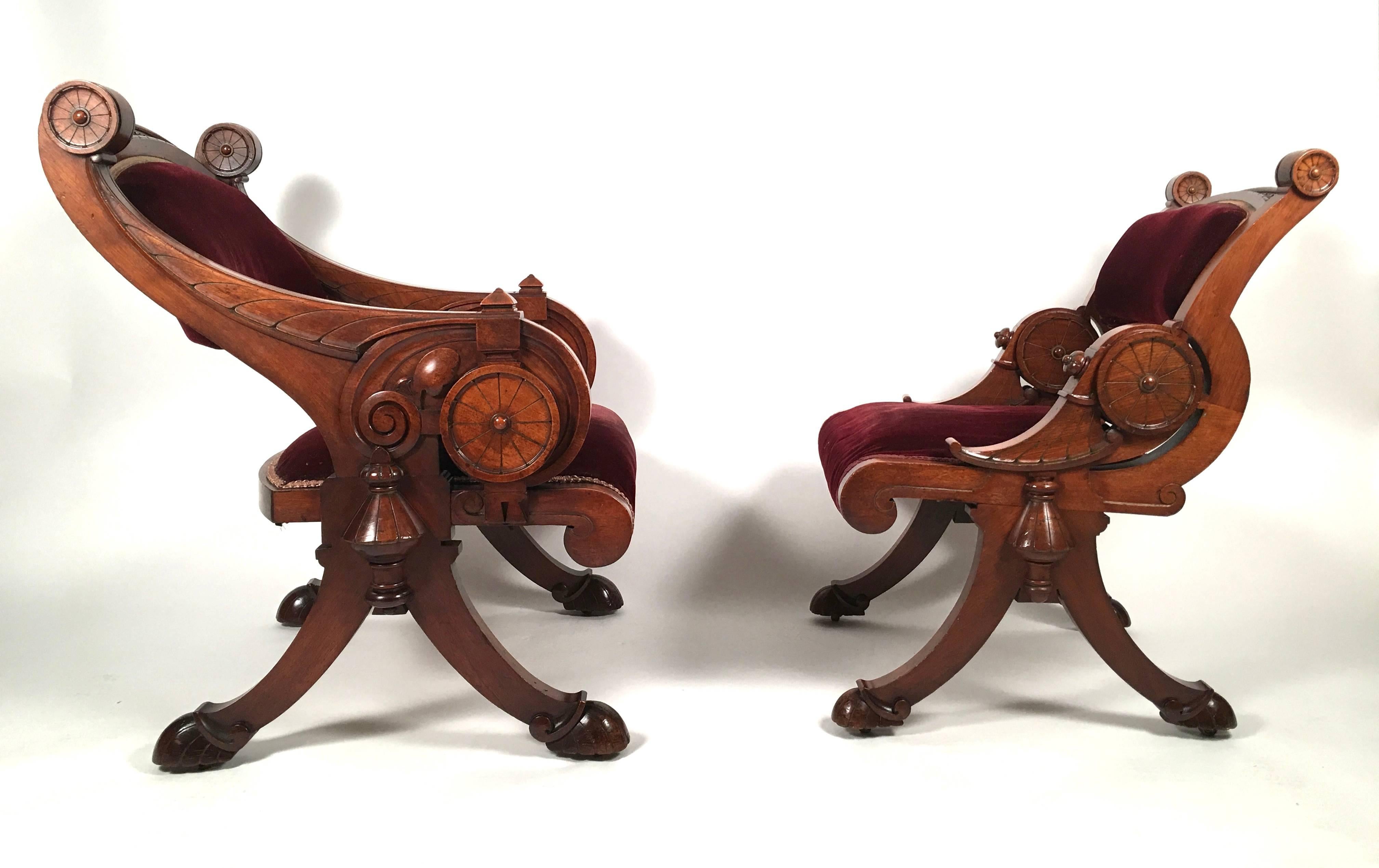 A beautifully made suite of American Renaissance Revival carved walnut furniture, comprising 2 arm chairs, one larger than the other, for gentleman and lady, and a matching foot stool which opens for storage. These sculptural chairs exhibit