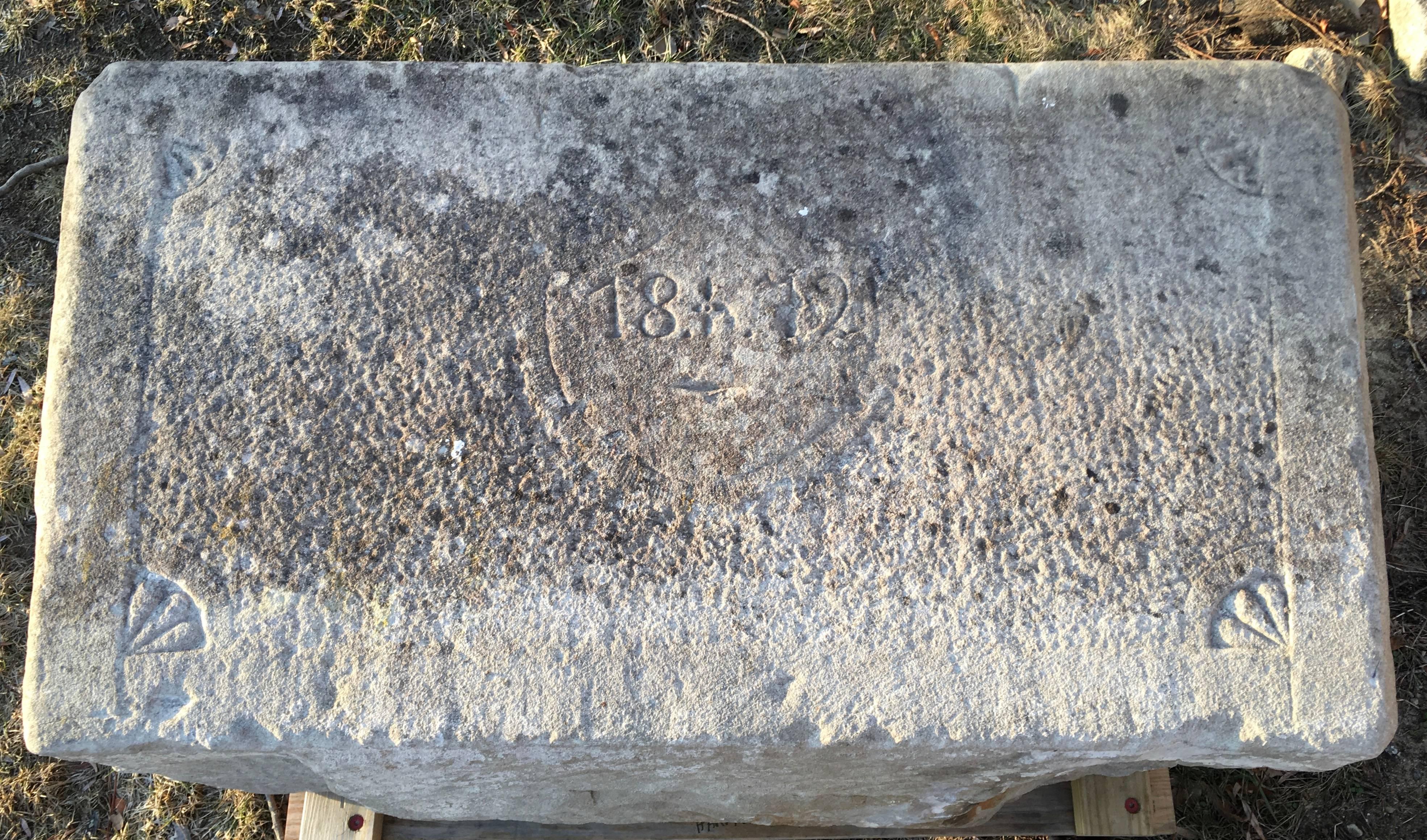 A 19th century carved limestone trough from Switzerland, of rectangular form with incised carved decoration on the front and back, dated 1872 with spandrels in the corners. Wonderful old lichen colored surface. This trough would be beautiful as