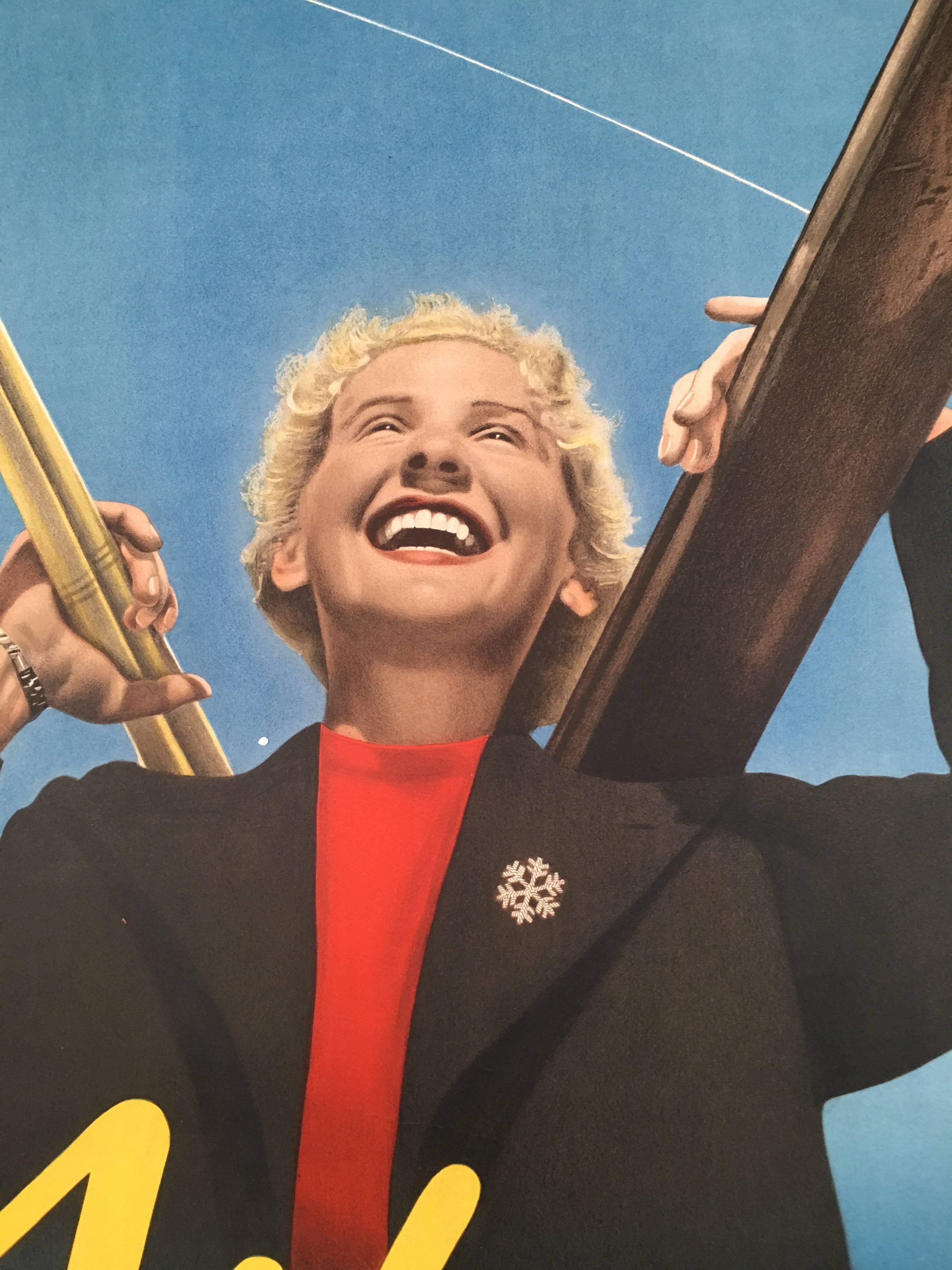 A striking pre-war collage ski poster featuring both photographic and graphic images advertising the alpine resort of Wengen, Switzerland, featuring an ebullient blond smiling woman carrying her skis and poles, wearing a red sweater with black