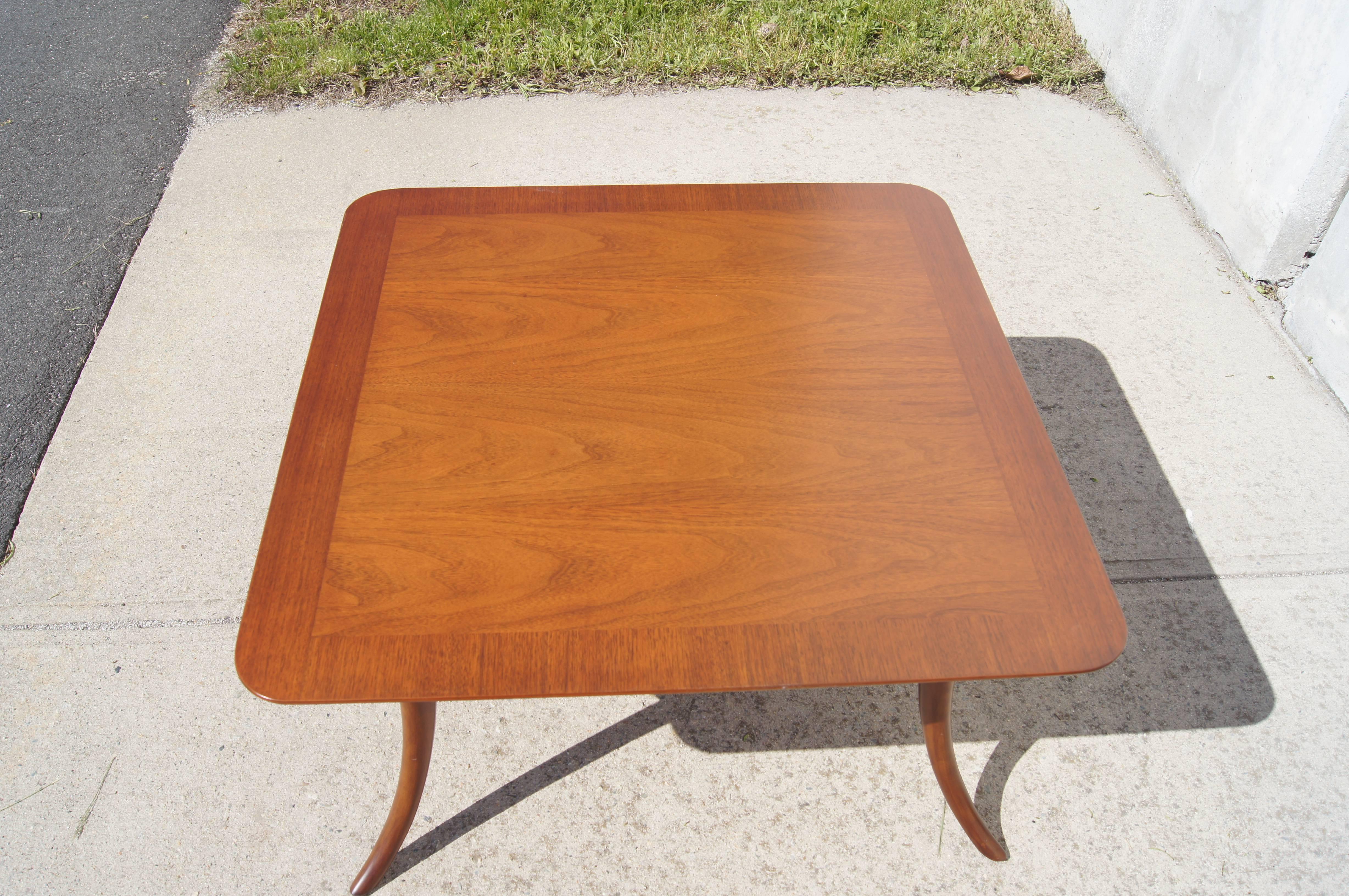 This two-tier mahogany coffee table by T.H. Robsjohn-Gibbings for Widdicomb exemplifies the grace of his work, from the softly contoured edges of its squared top to the curvaceous sweep of its saber legs, reminiscent of the Klismos chair.