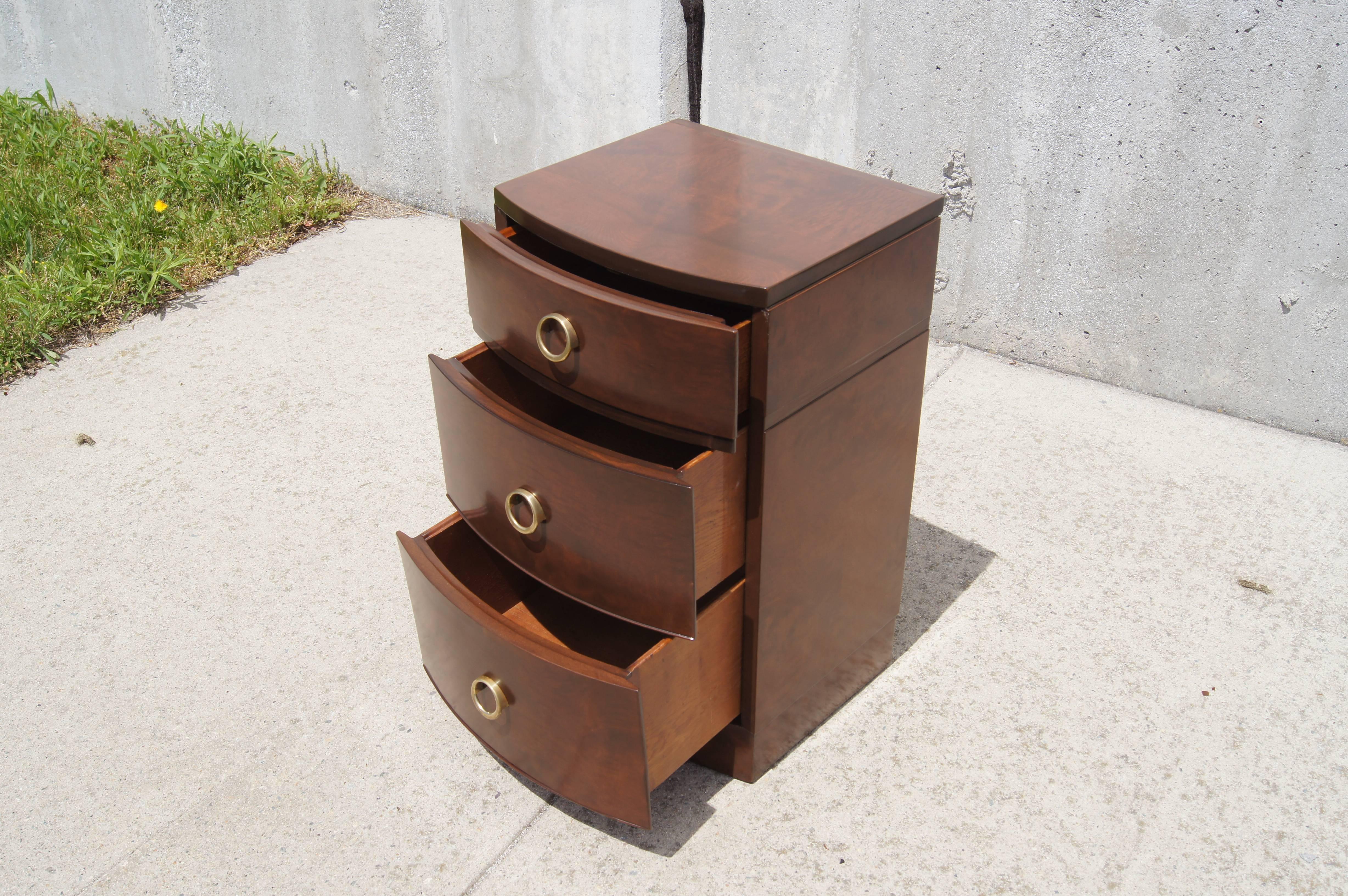 This bow-front nightstand is a great example of American Art Deco furniture from the 1930s. Raised circular brass pulls complement the handsome myrtle burl.

Corresponding four-drawer and five-drawer dressers are available.