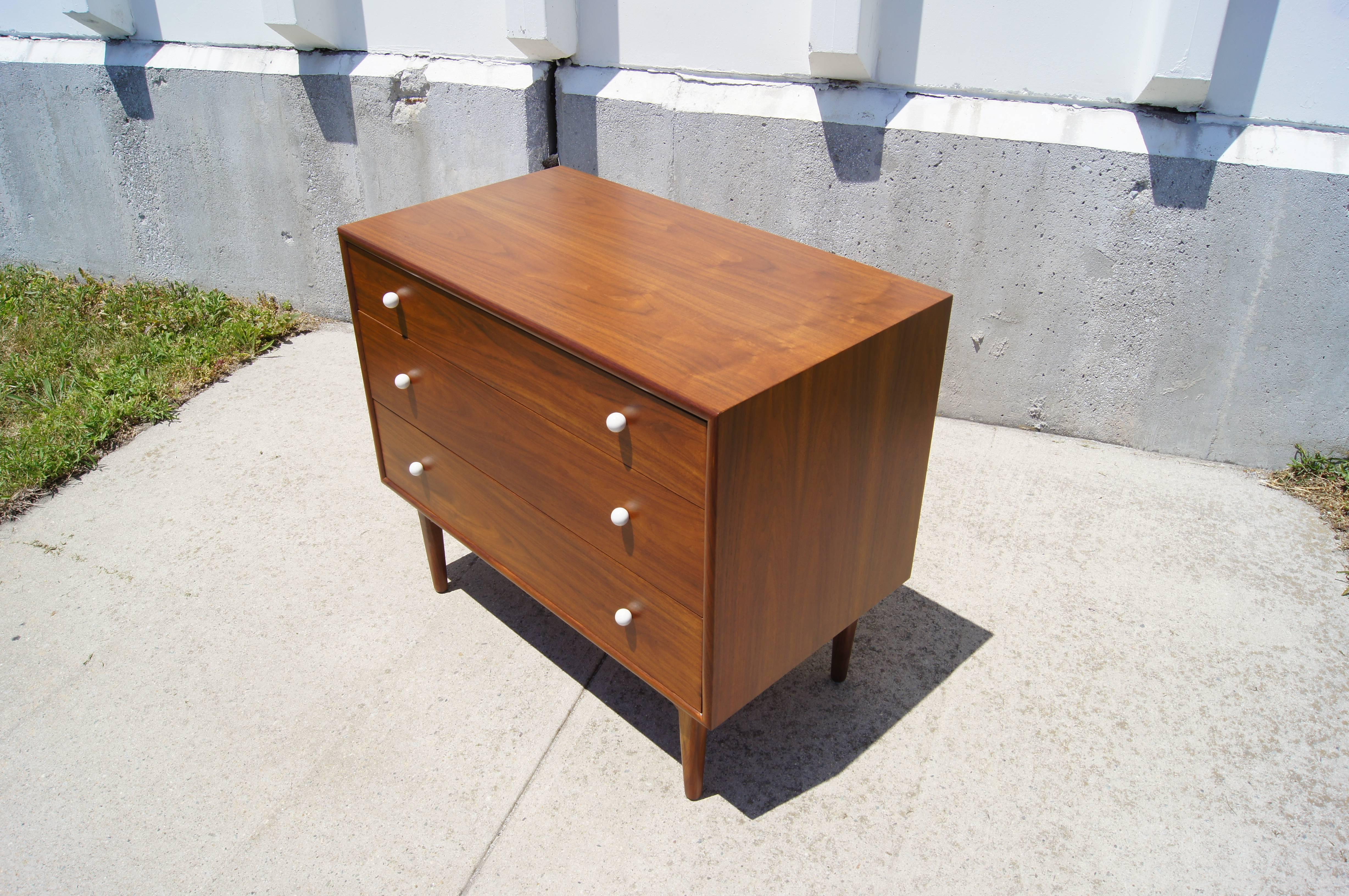 Kipp Stewart and Stewart MacDougall designed this dresser as part of Drexel’s popular Declaration collection. Their signature white porcelain pulls highlight the beauty of the oiled walnut. The three-drawer case sits atop tapered legs of solid