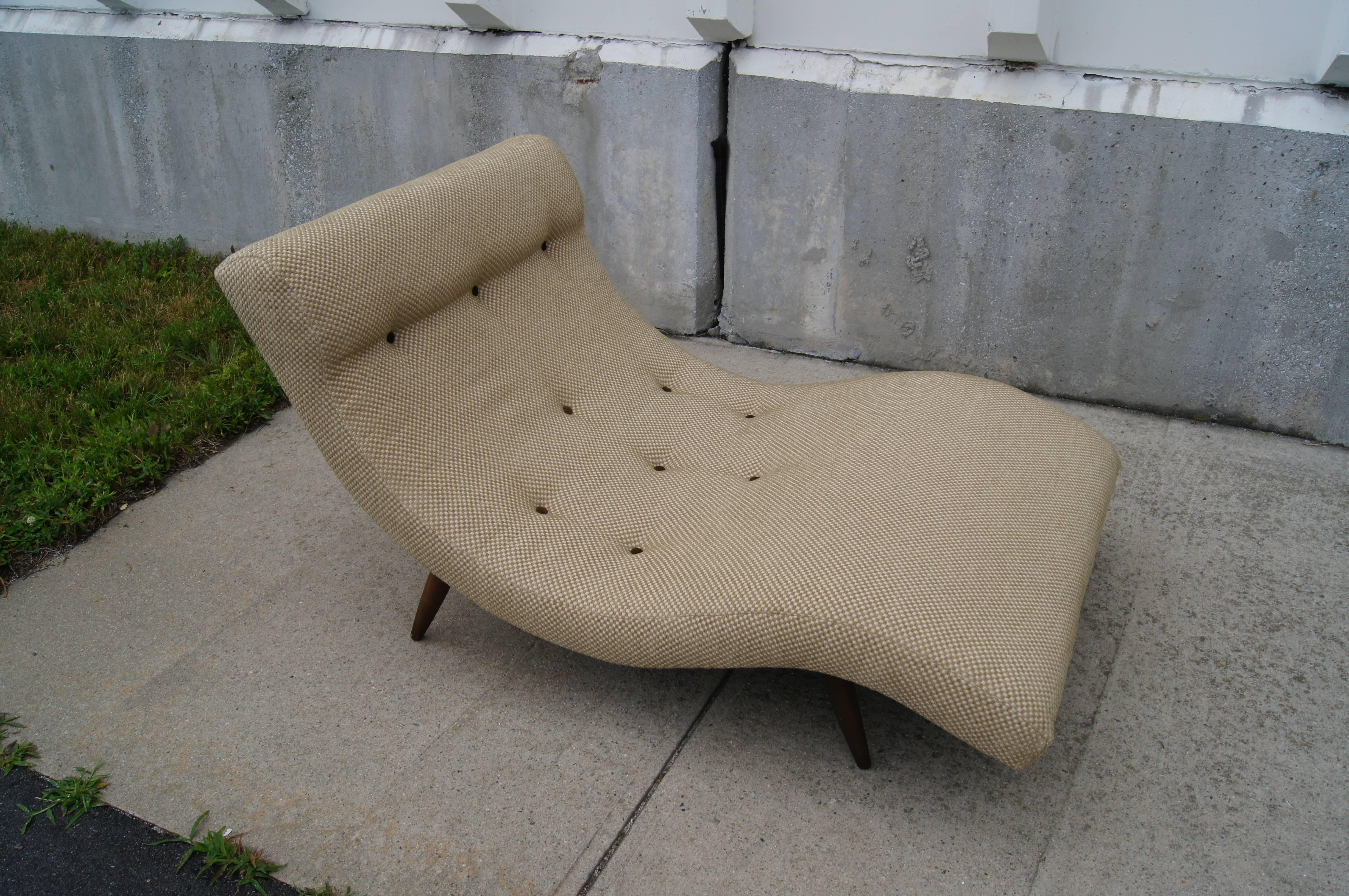 Adrian Pearsall's design for Craft Associates places a dramatic wave of upholstery on splayed legs of walnut. This chaise longue is large enough for two to lounge comfortably together.

The soft bouclé́ is tufted with contrasting brown suede