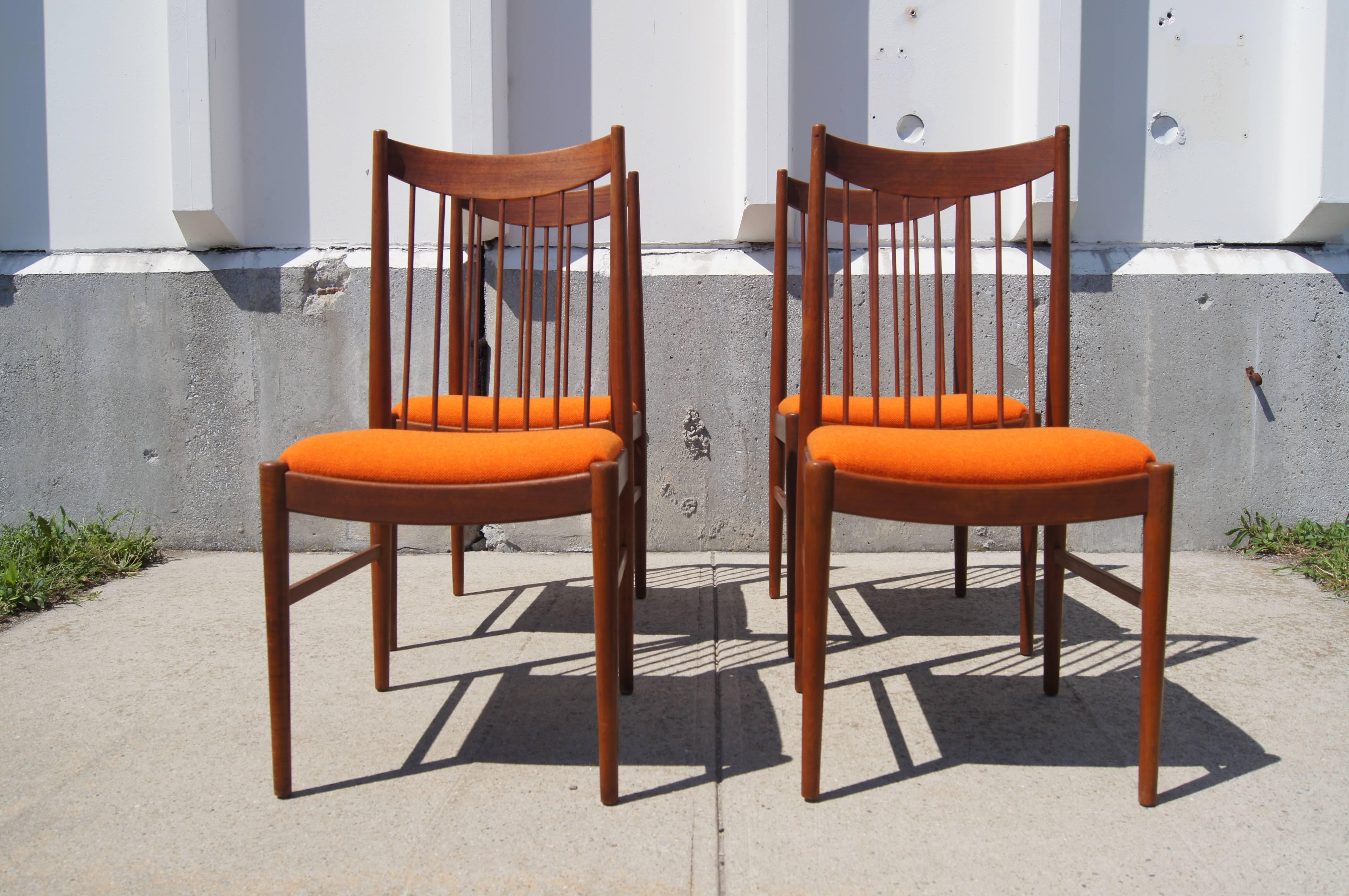 Arne Vodder designed these high-back dining chairs for Sibast in the 1960s. They feature slender teak frames with slanted dowels joined to a graceful curved backrest. They have been reupholstered with Maharam's Hallingdal wool textile in a burnt