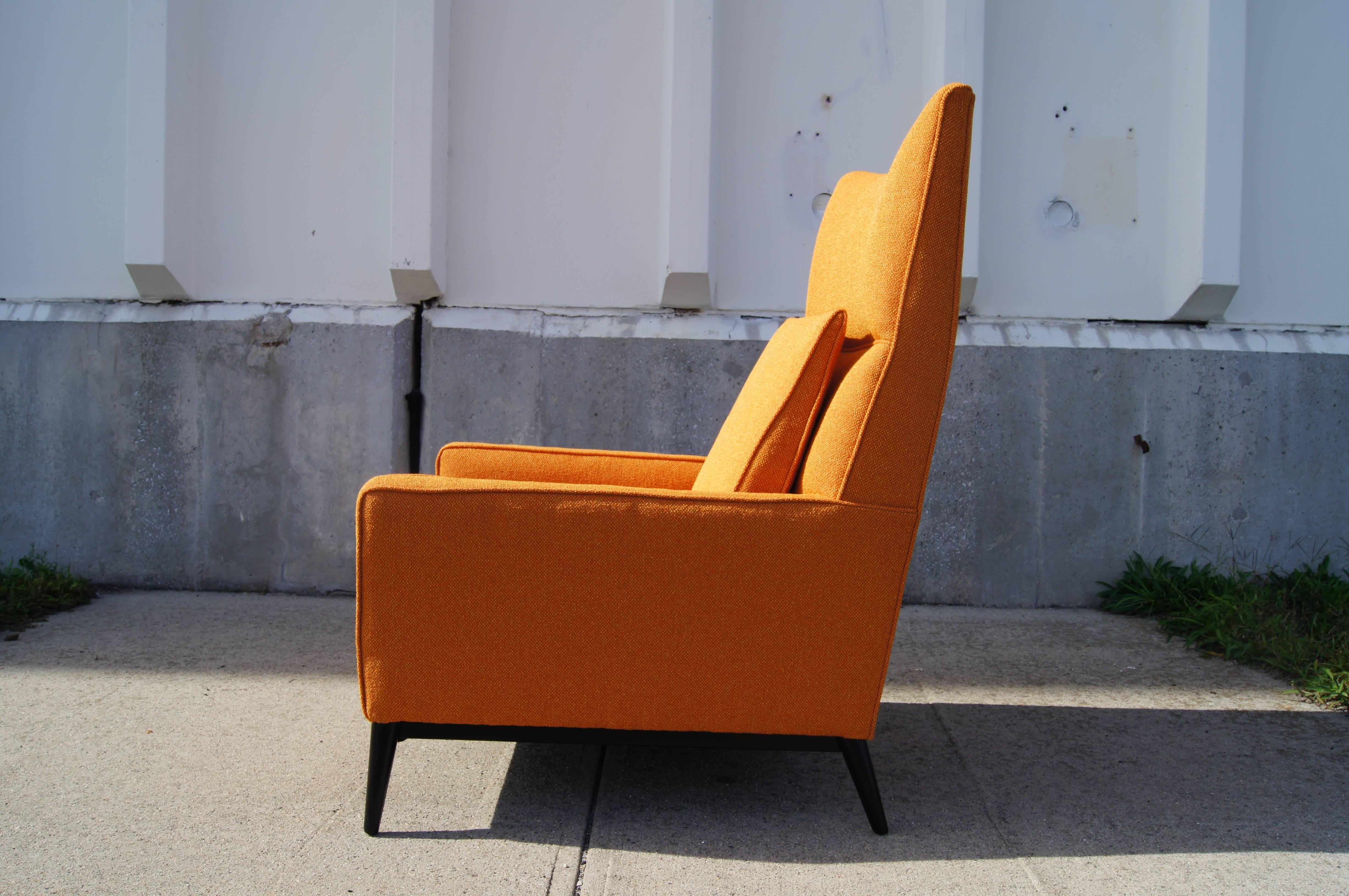 Paul McCobb designed this comfortable high-back lounge chair, model 314, for Directional Furniture. Its pointed wings, splayed tapering legs and wedge-shaped back cushion create a distinctive play of angles.

The chair has been reupholstered in