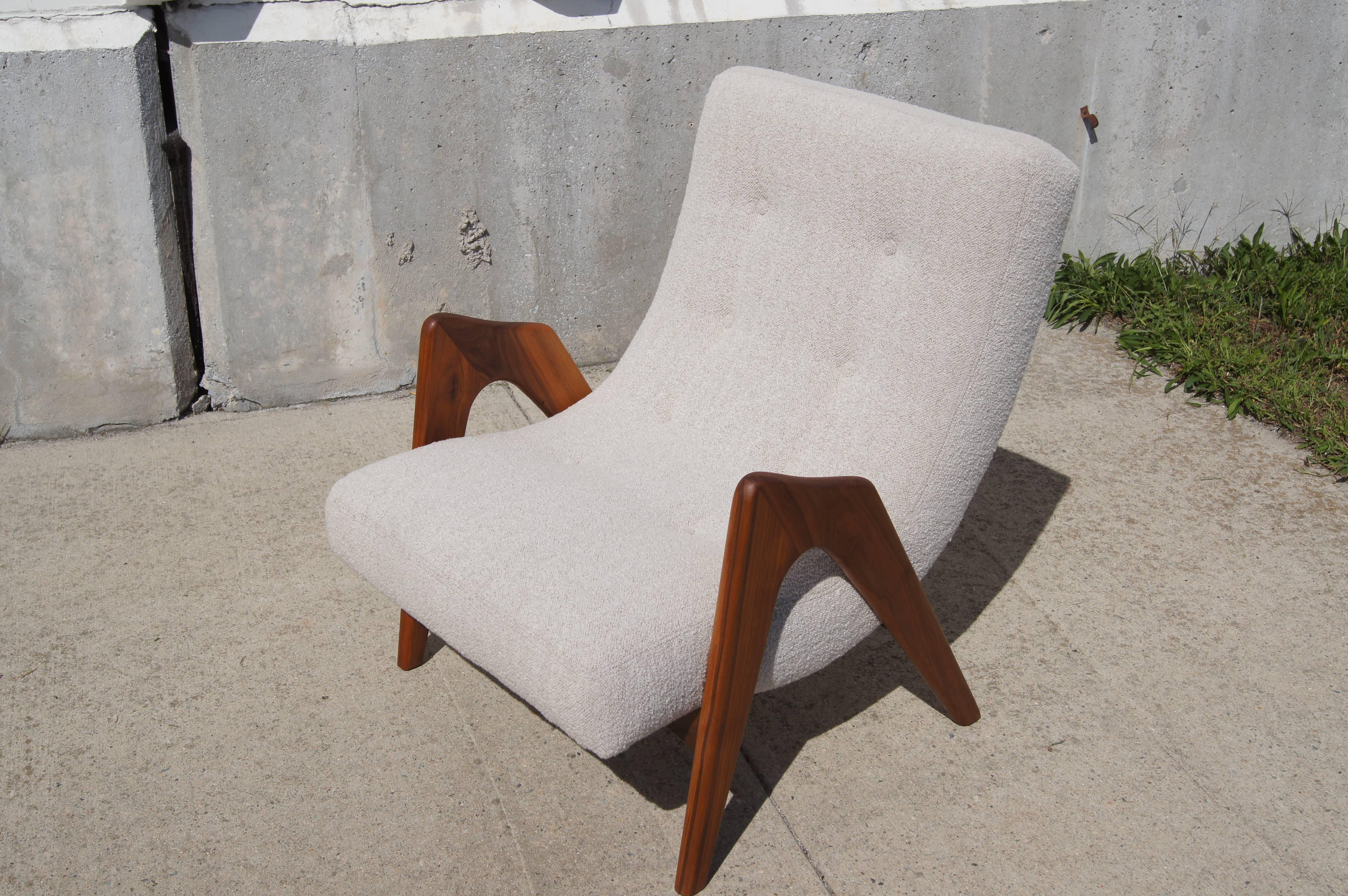 Adrian Pearsall's lounge chair, model 705-CW, for Craft Associates rests a gently curved tufted seat between an exuberant arc of solid walnut that forms both legs and armrests.

The chair has been reupholstered in Designtex's “Lambert” fabric in