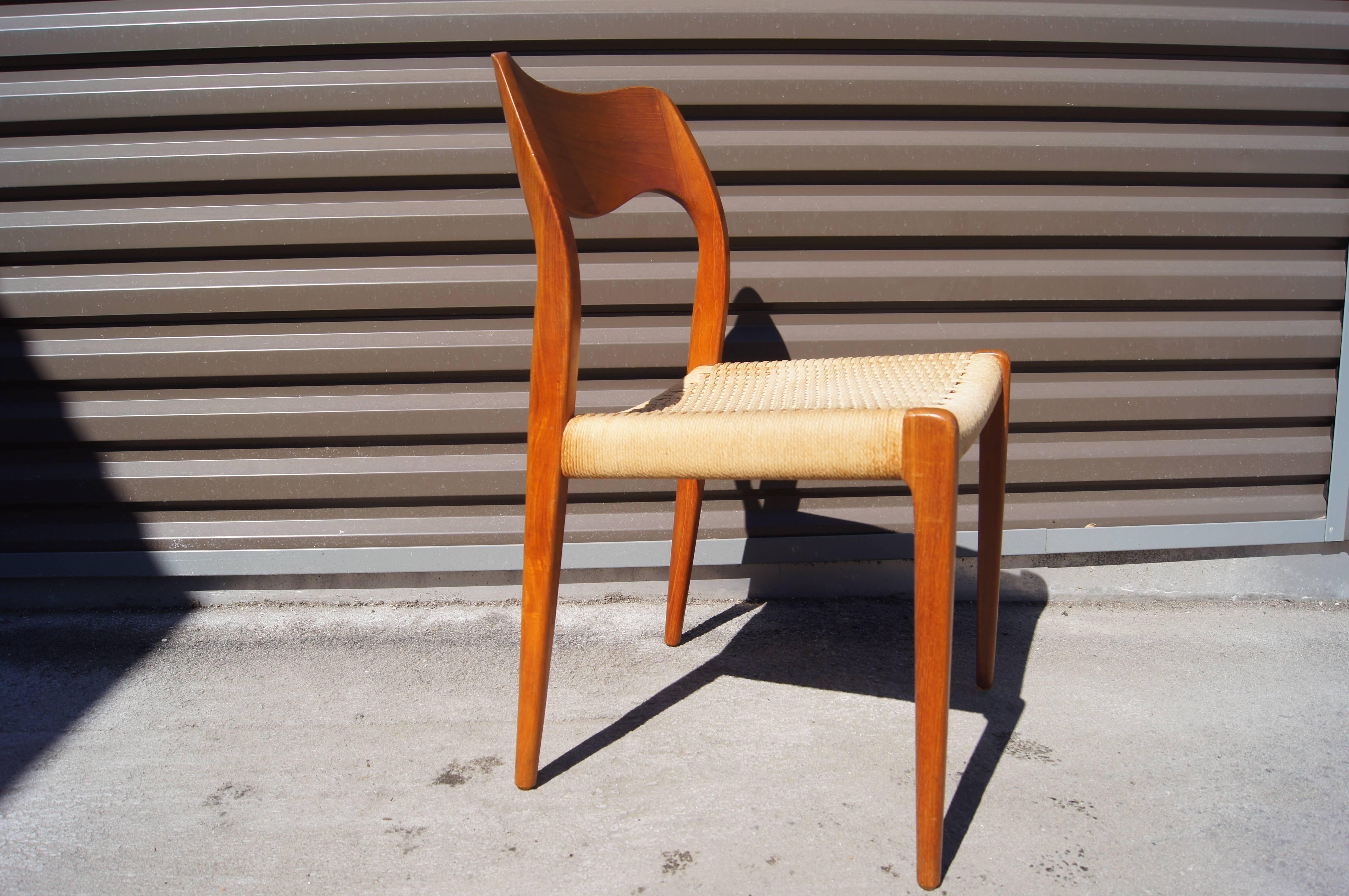 Designed in 1951 by Niels Otto Møller for J. L. Møllers Møbelfabrik, these Classic Danish dining chairs, model 71, feature graceful teak frames and
handwoven papercord seats.