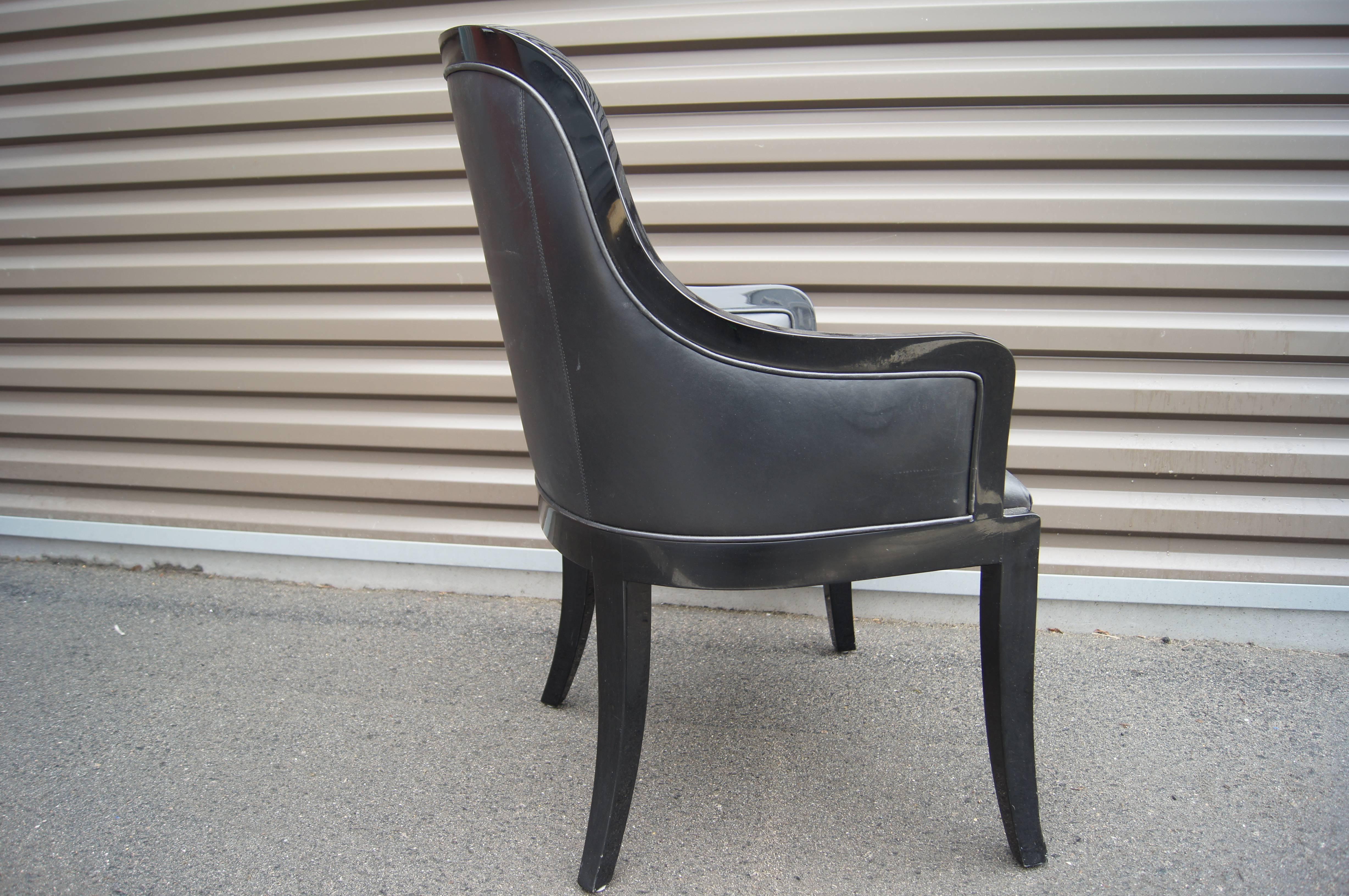 Karl Springer's sleek and chic Regina armchair features a curvaceous frame of high-gloss black lacquer and tailored black leather upholstery

Two armchairs are available.