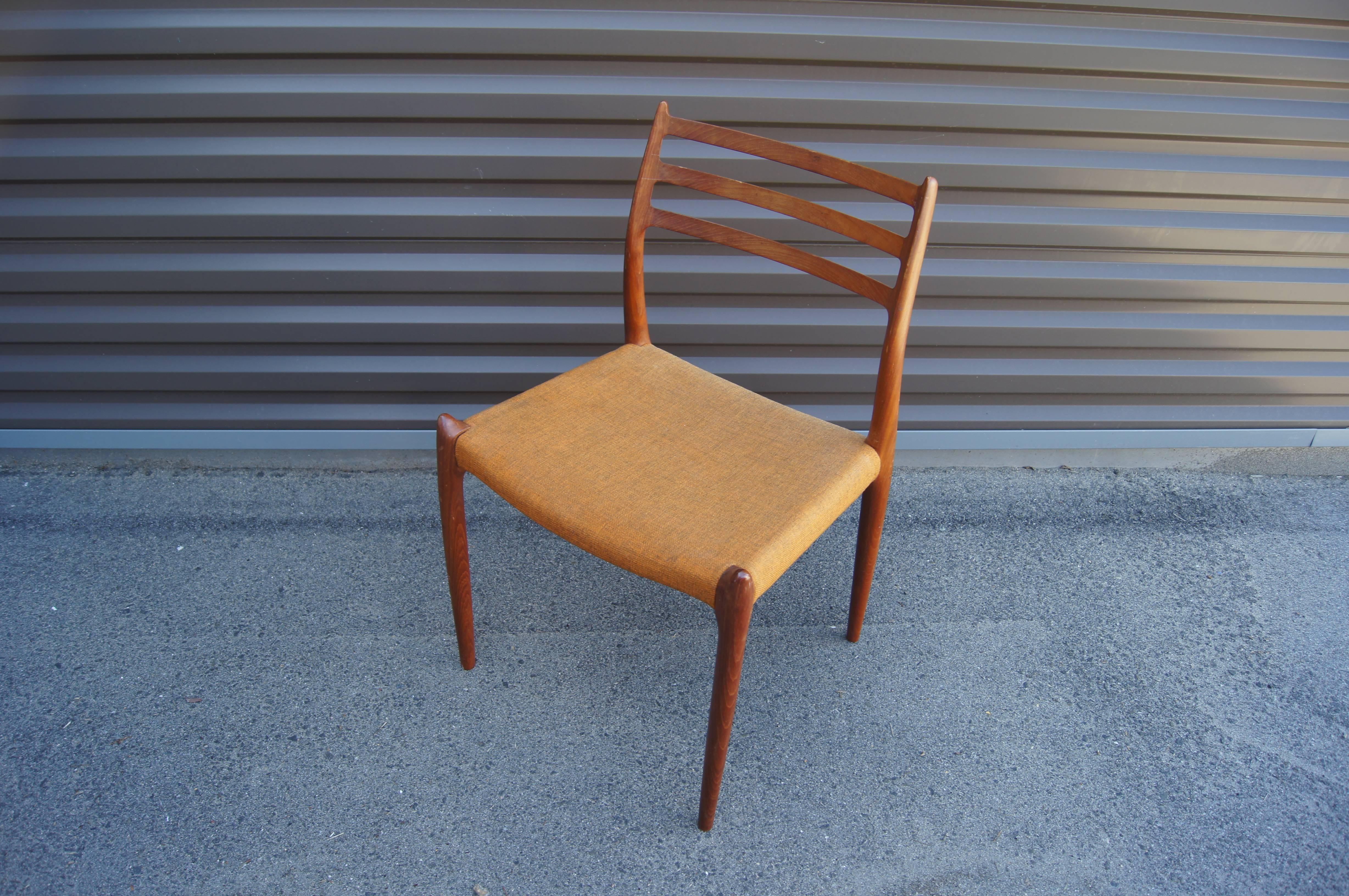 Niels O. Møller designed this side chair, model 78, in 1954 for J.L. Møllers Møbelfabrik. The solid teak frame has delicate lines, with hornlike details on the backrest and where the legs meet the seat. 

All six chairs retain the original woven
