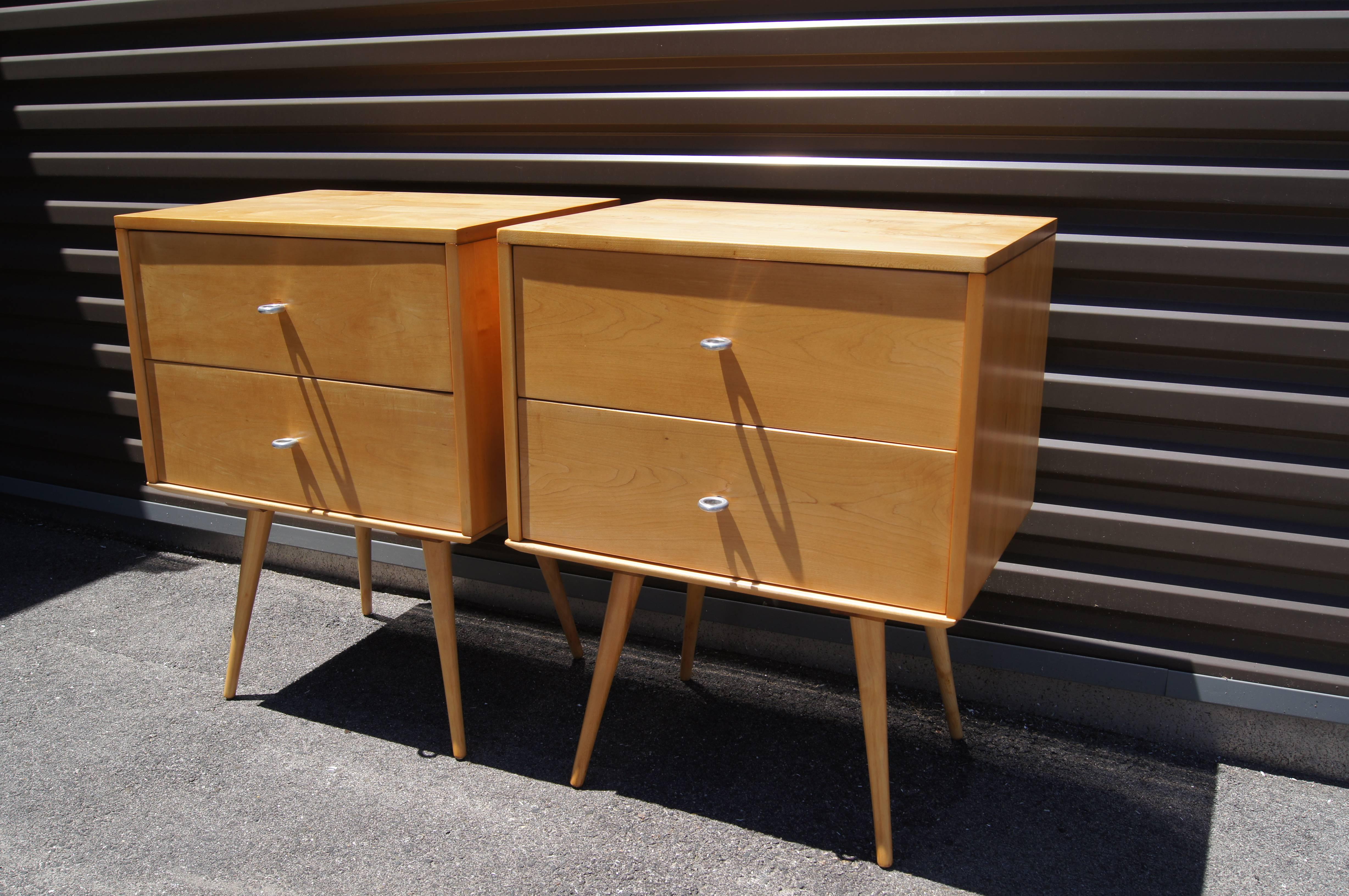 Designed by Paul McCobb for Winchendon Furniture's Planner Group line, each nightstand is composed of a two-drawer maple case piece that sits atop a small detached maple table. The nightstands have been expertly refinished but feature the original