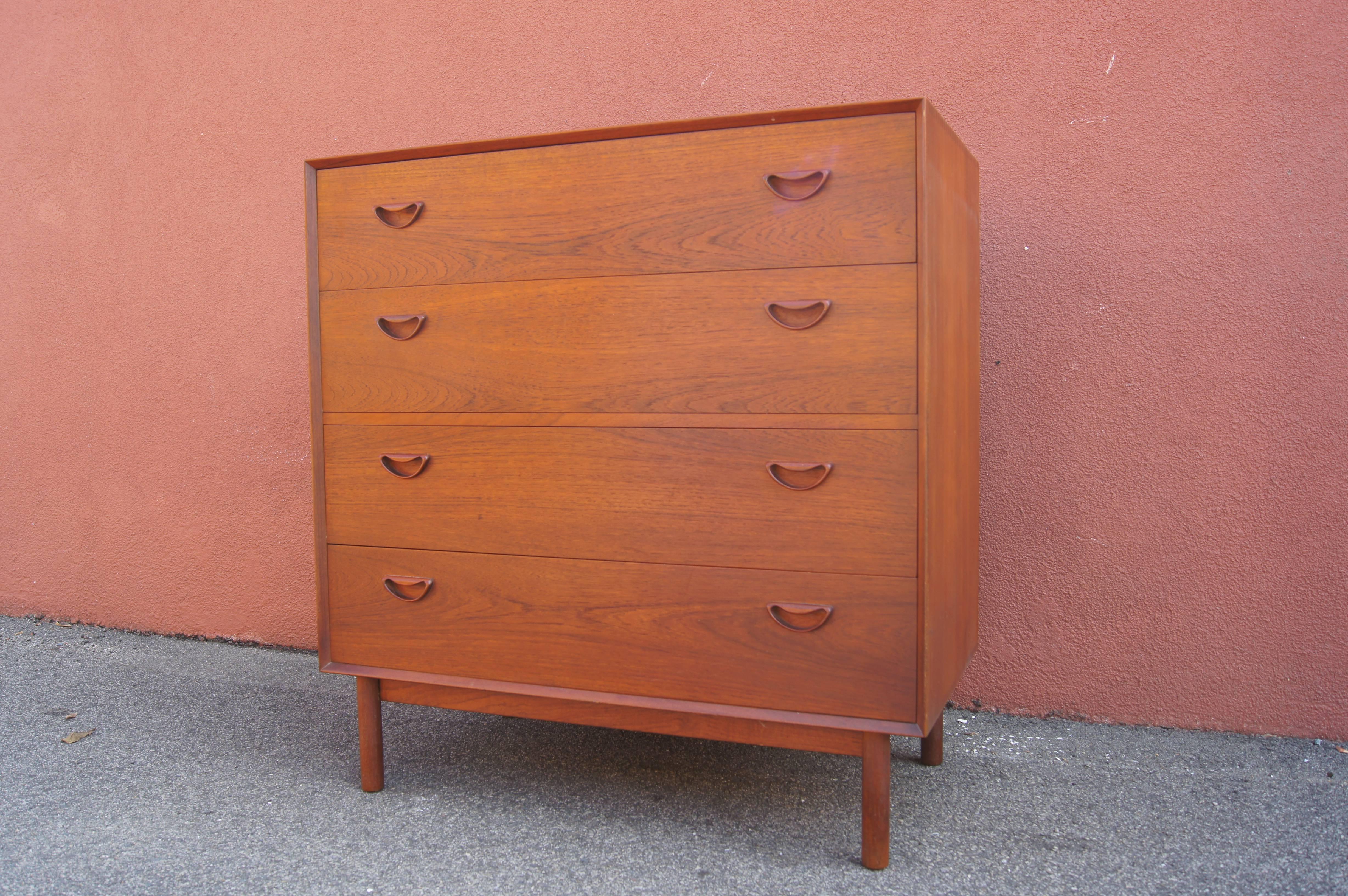 Peter Hvidt and Orla Mølgaard-Nielsen designed this handsome gentleman's dresser for J. Jacobsen and Sonner; it was imported from Denmark by John Stuart, whose mark appears underneath. The teak case sits on plinth base and features exposed finger