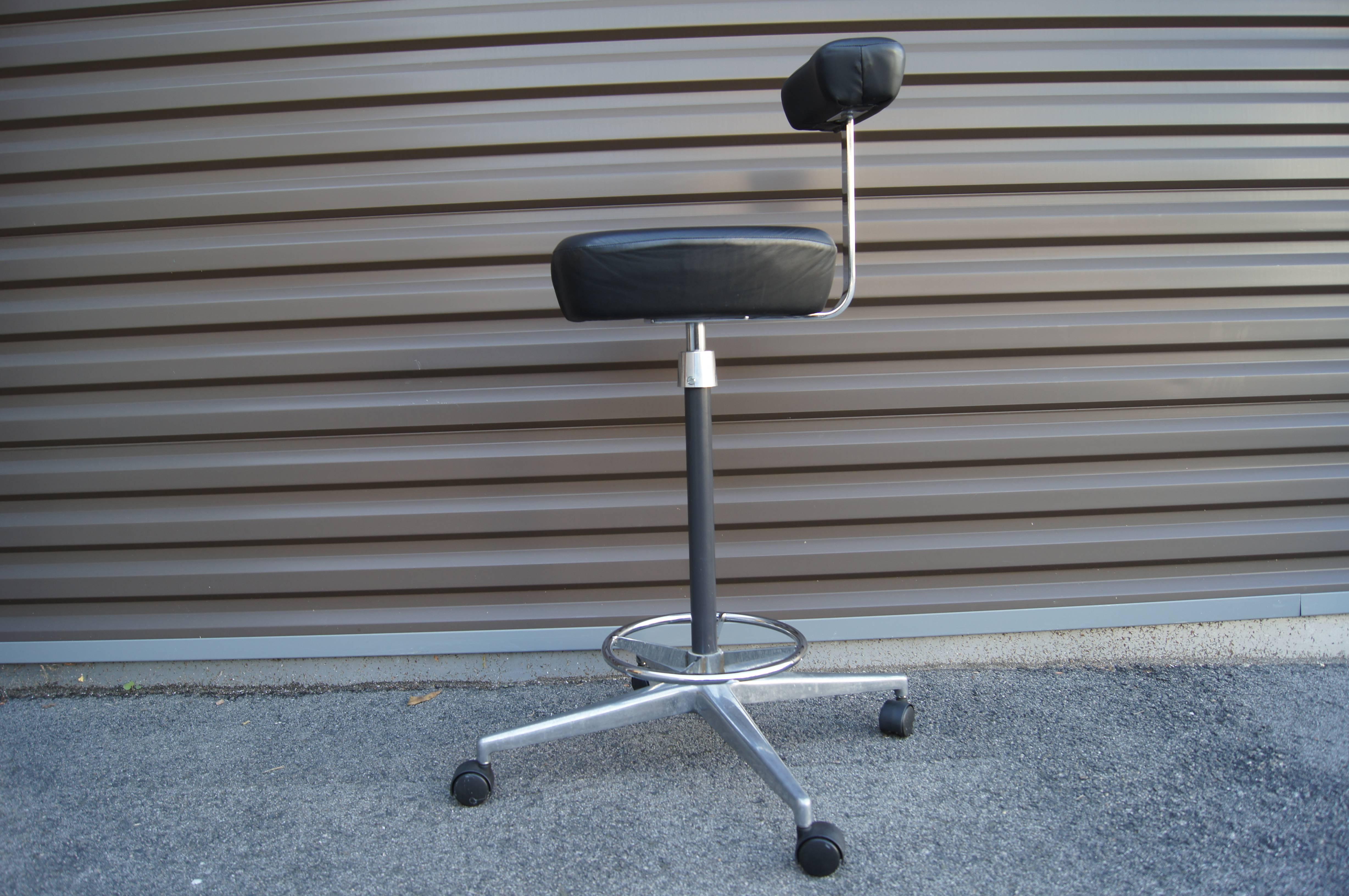 Designed in 1964 by George Nelson and Robert Propst, the Perch Stool was part of Herman Miller's flexible Action Office System. This drafting stool features a chrome-plated frame with a ring footrest and a high seat and small backrest, both