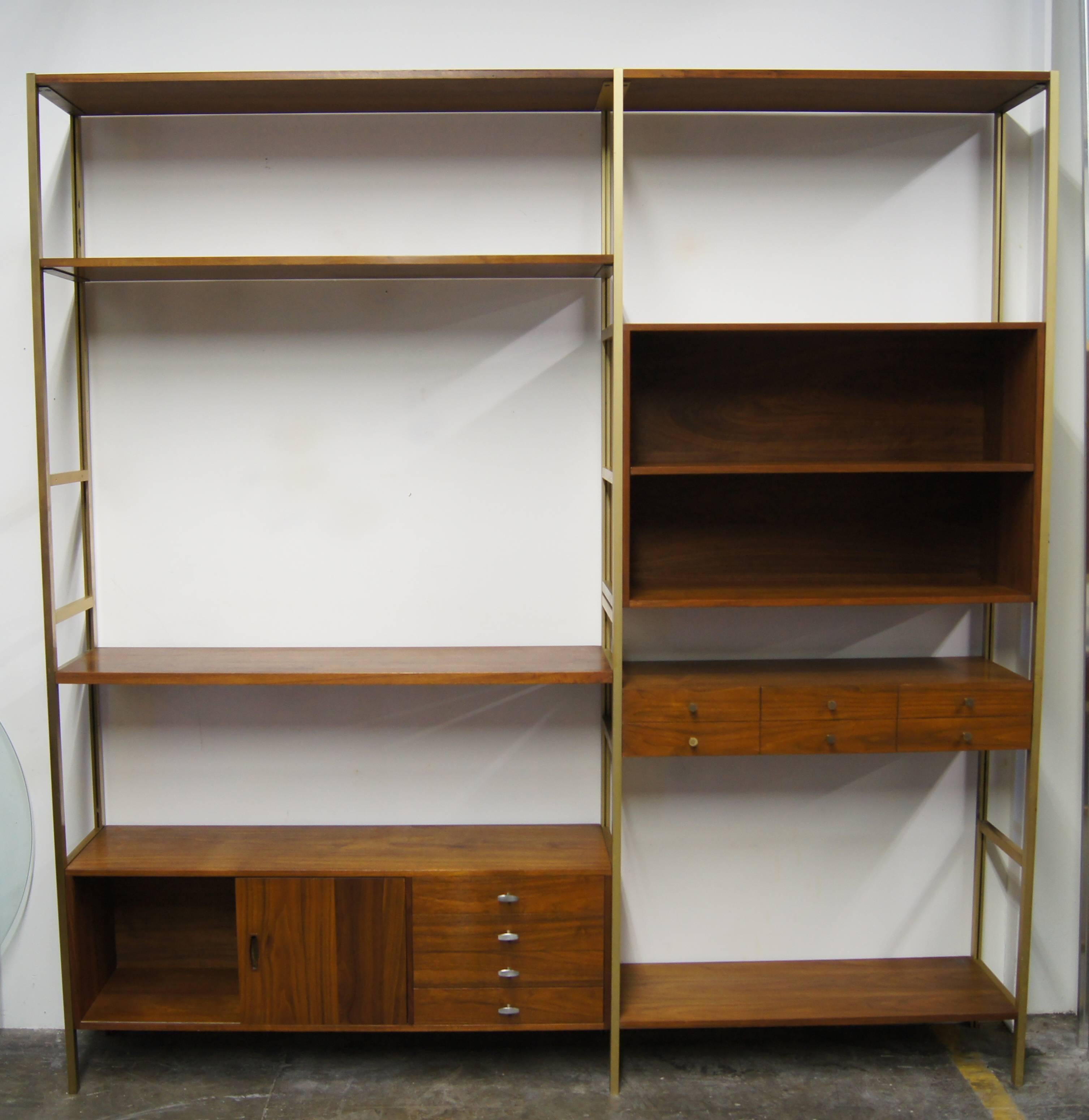 This one-of-a-kind wall unit was custom-made for Herb Sacks by H Sacks & Sons in Brookline, MA. It features a brass frame with numerous walnut shelves and storage components, including a small component with six drawers and a larger section with