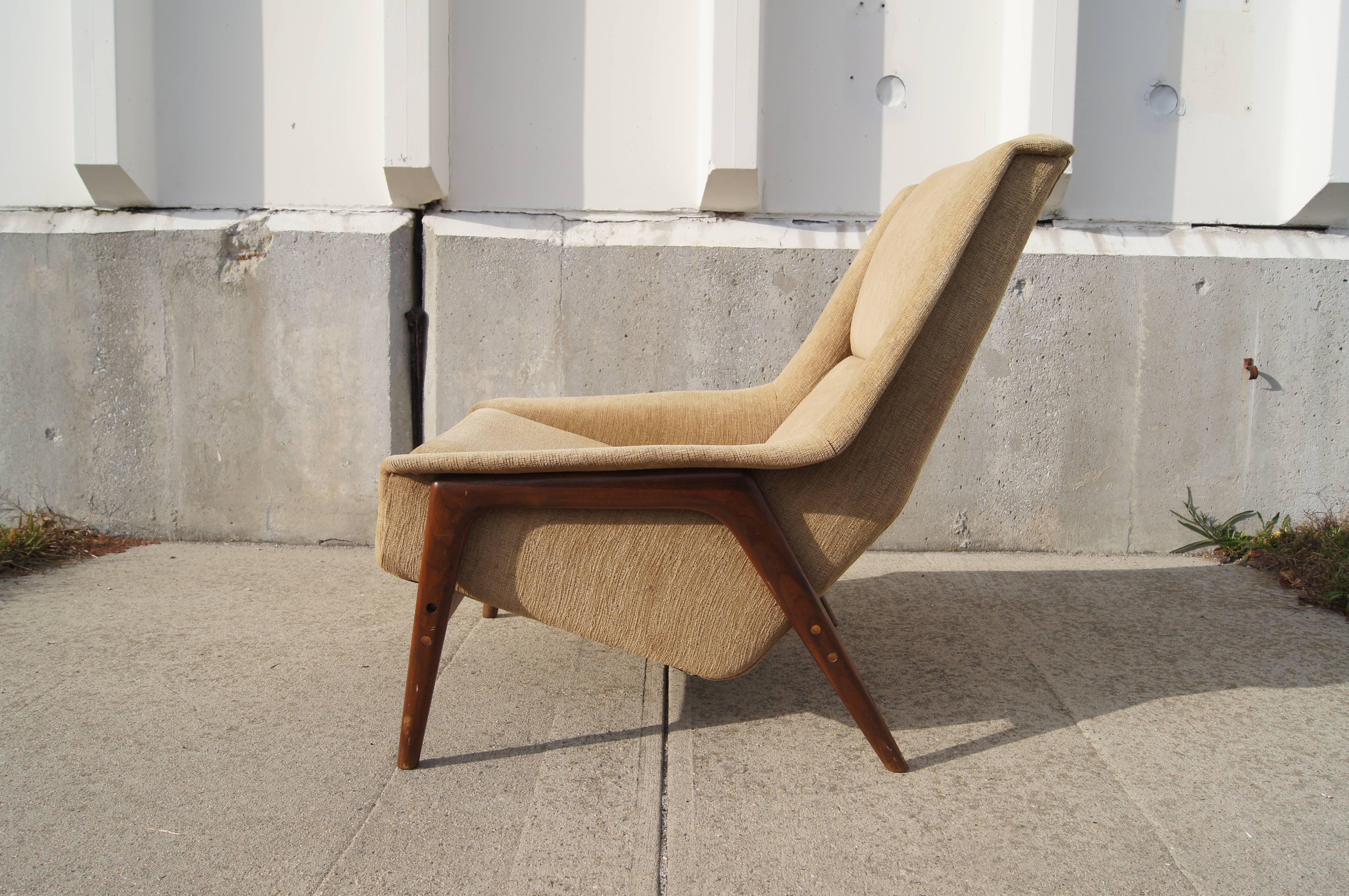 Designed by Folke Ohlsson for the Swedish manufacturer Dux, this lounge chair offers a supremely comfortable seat within an exposed teak frame. 

The chair was previously reupholstered.
