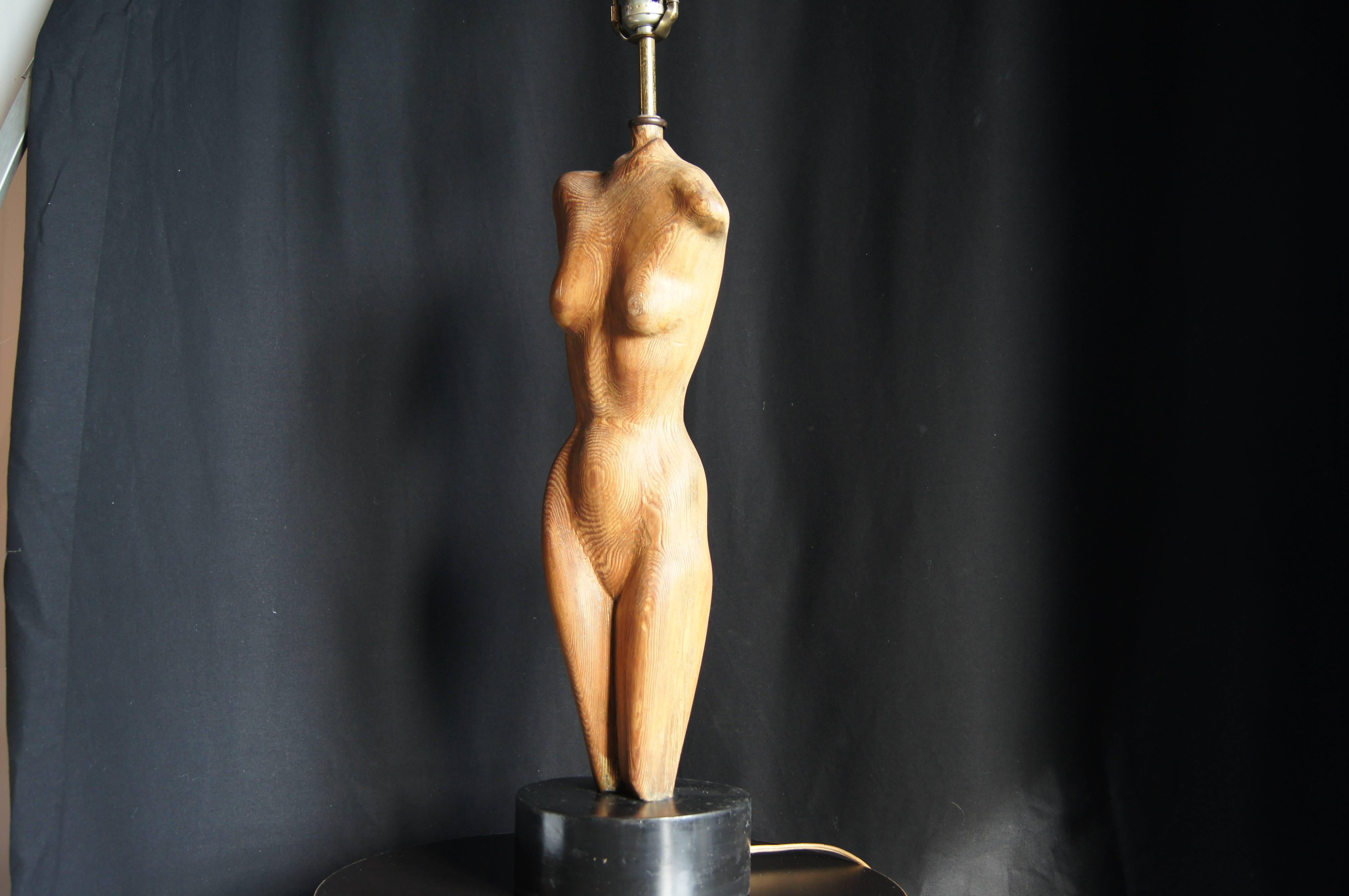 This table lamp by Yasha Heifetz features a sculpture of an elongated female torso supporting a single socket. 