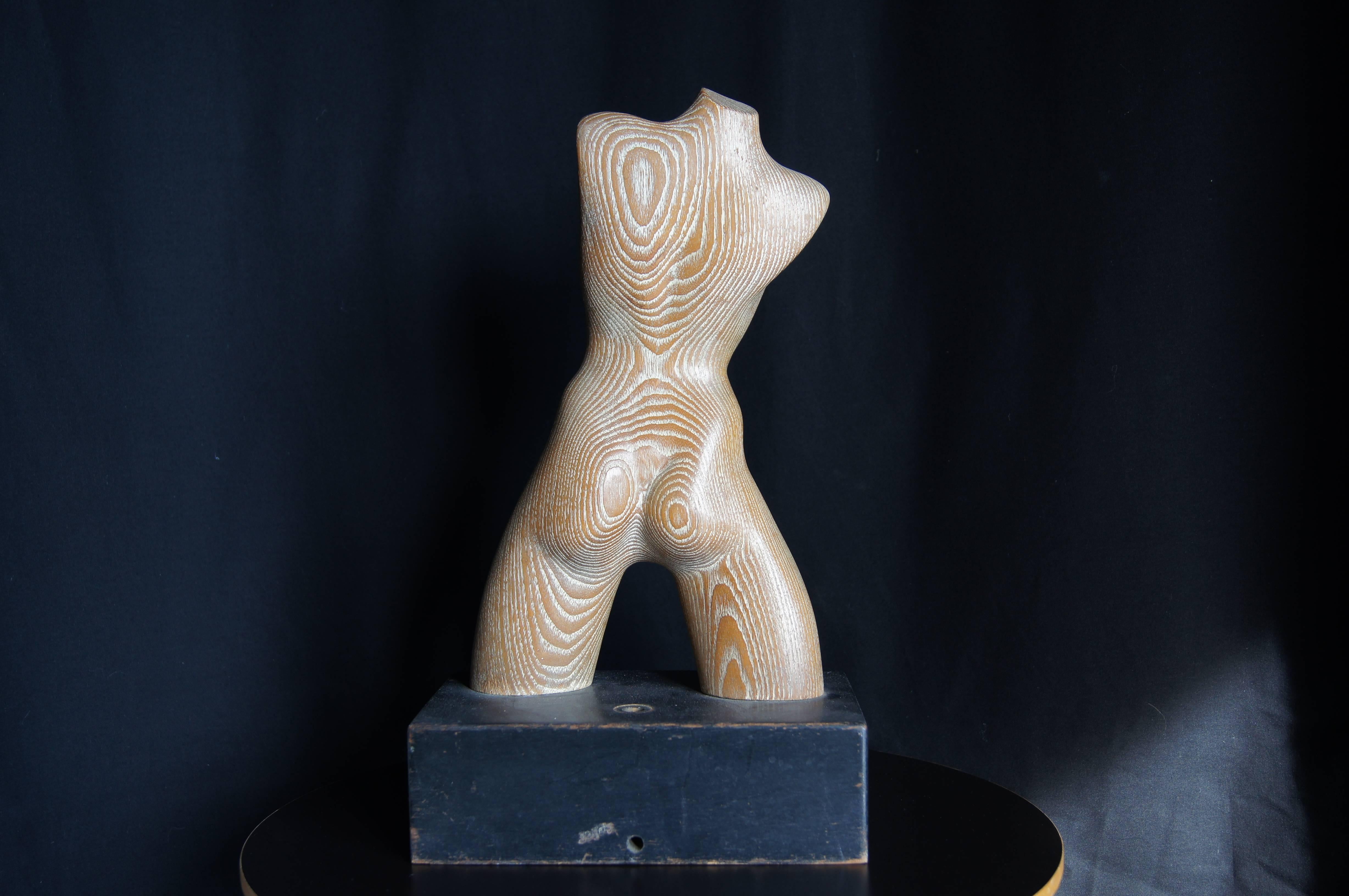 Yasha Heifetz carved this figure of a female torso from coursed oak, using the grain of the wood expressively.

The Heifetz Manufacturing Company was founded in 1938 and by the fifties was well known for its lamps. This sculpture sits on a base with