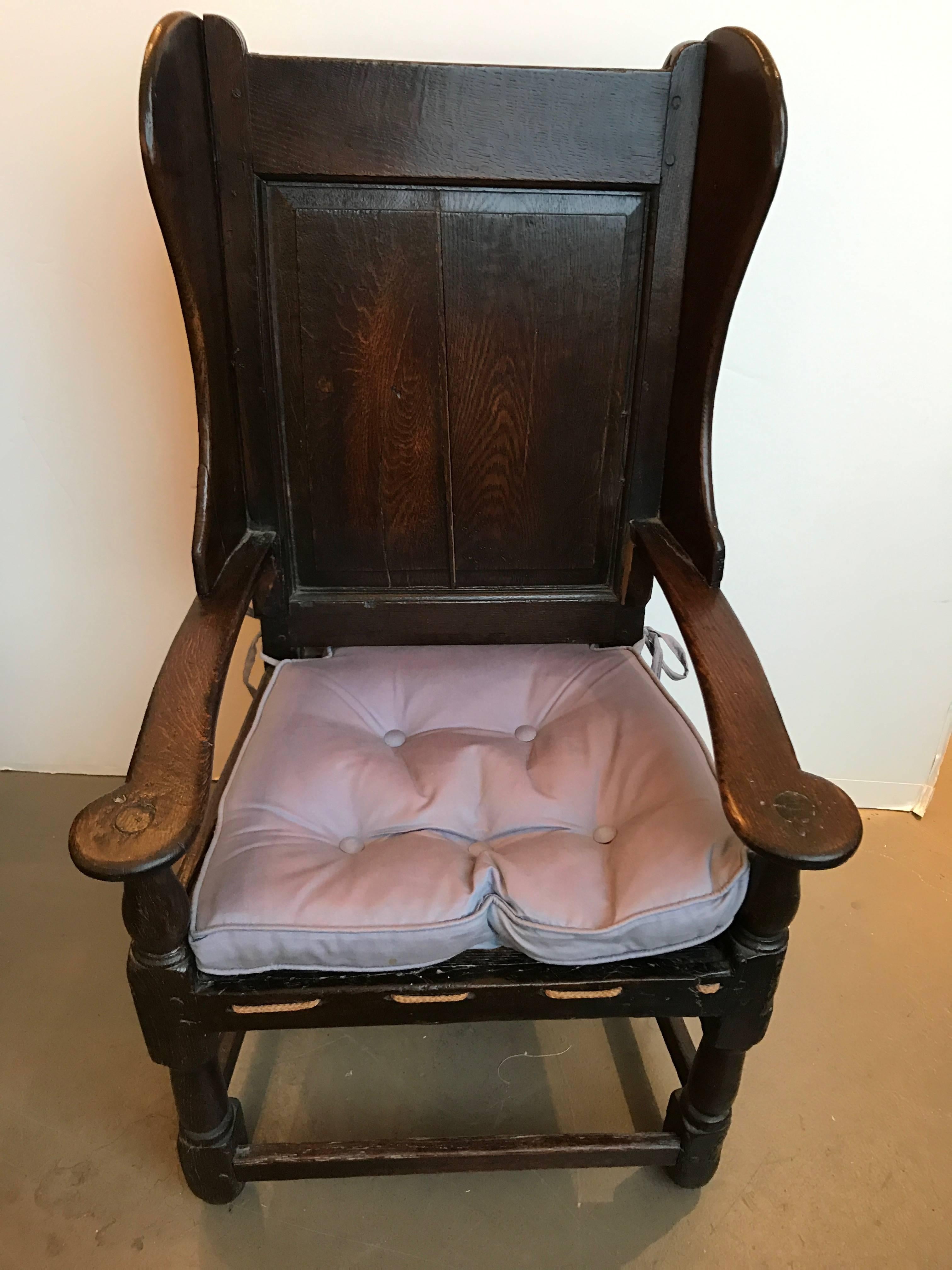 18th century English oak wing chair with rope seat.