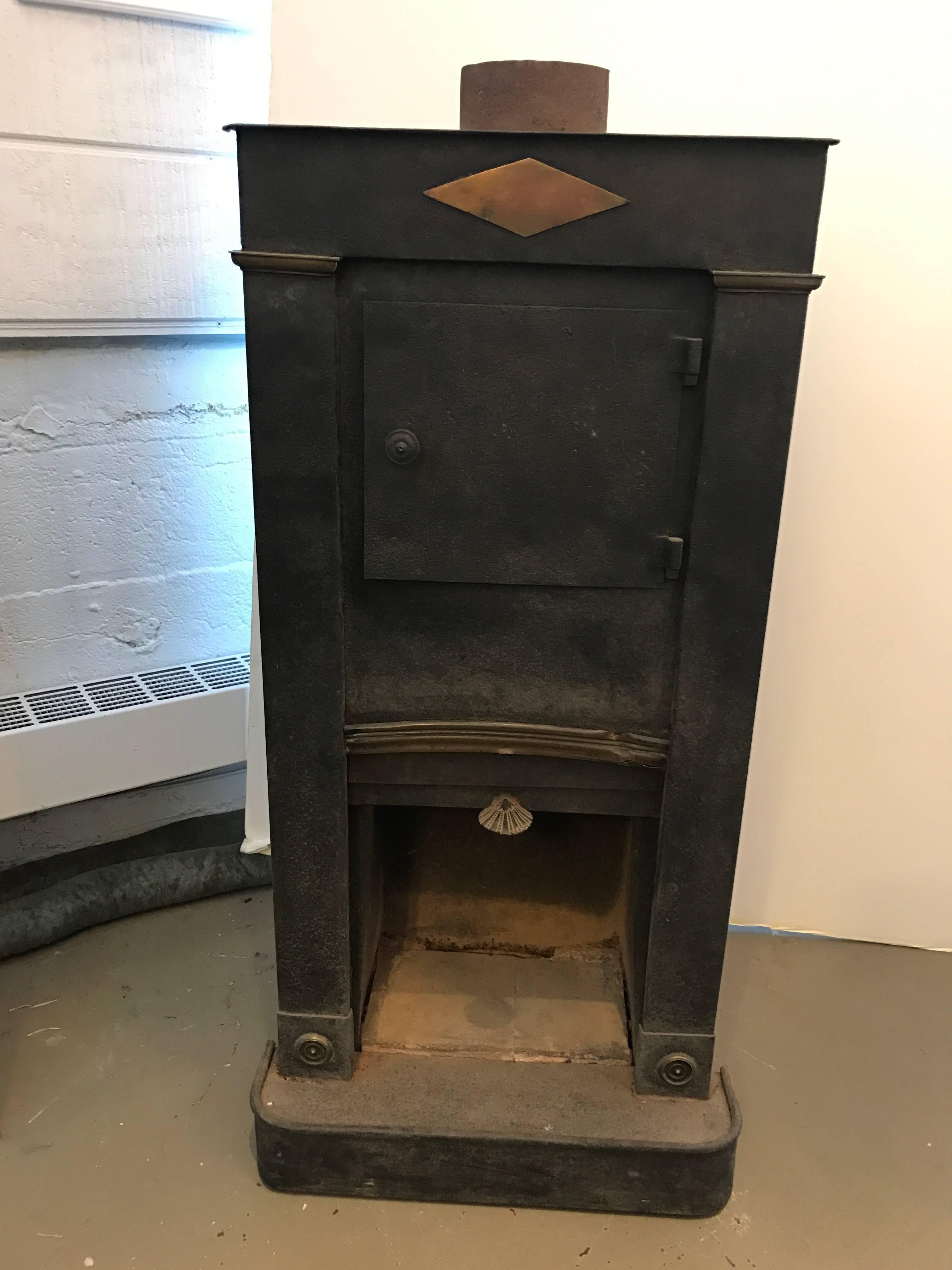 Early 19th century iron wood burning corner stove. The stove was in Charles Spada's home in France for many years. In addtion to being handsome, it's in good condition. 