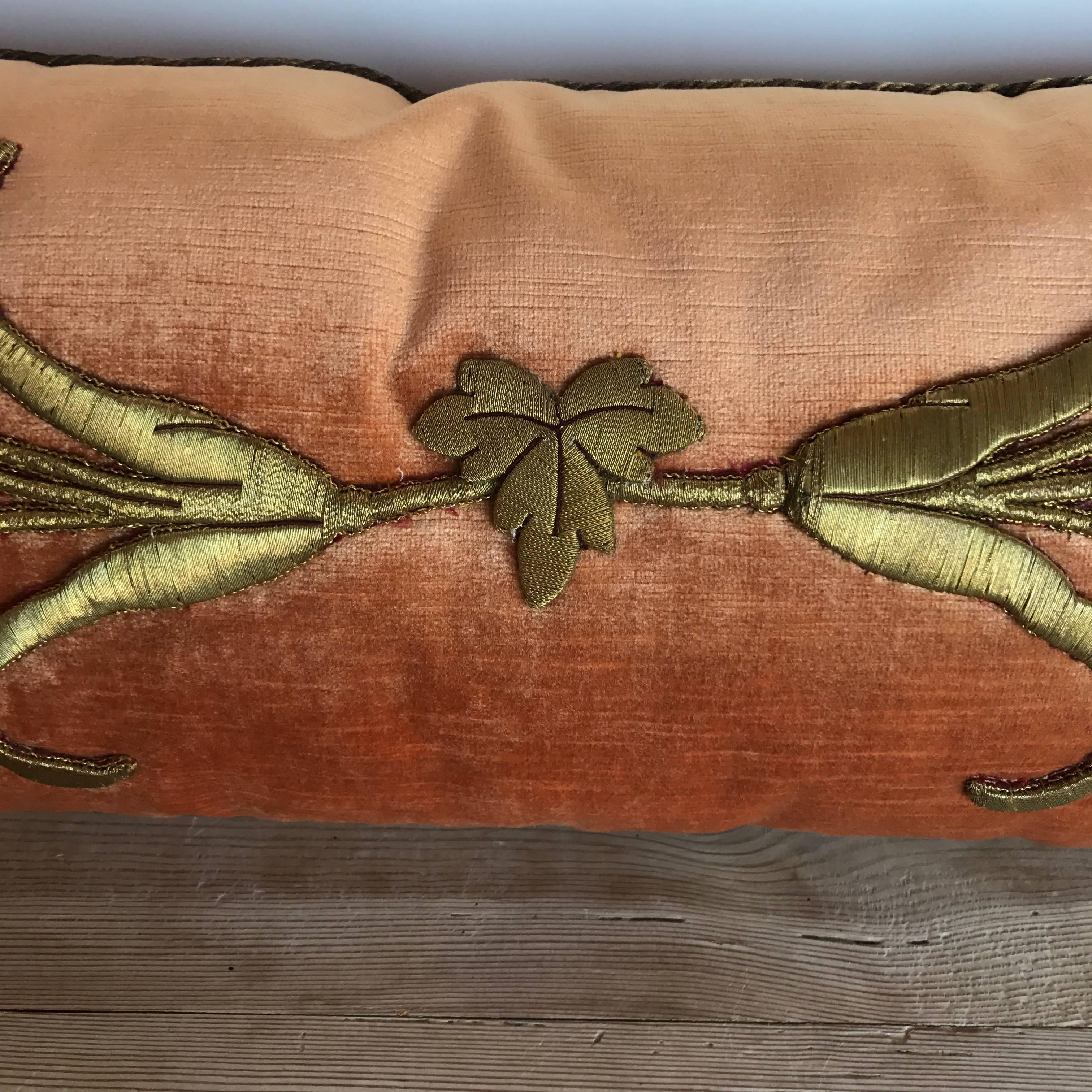 Antique European raised gold metallic embroidery of vining flowers and leaves on melon velvet. Hand trimmed with vintage gold metallic cording knotted in the corners. Down filled.