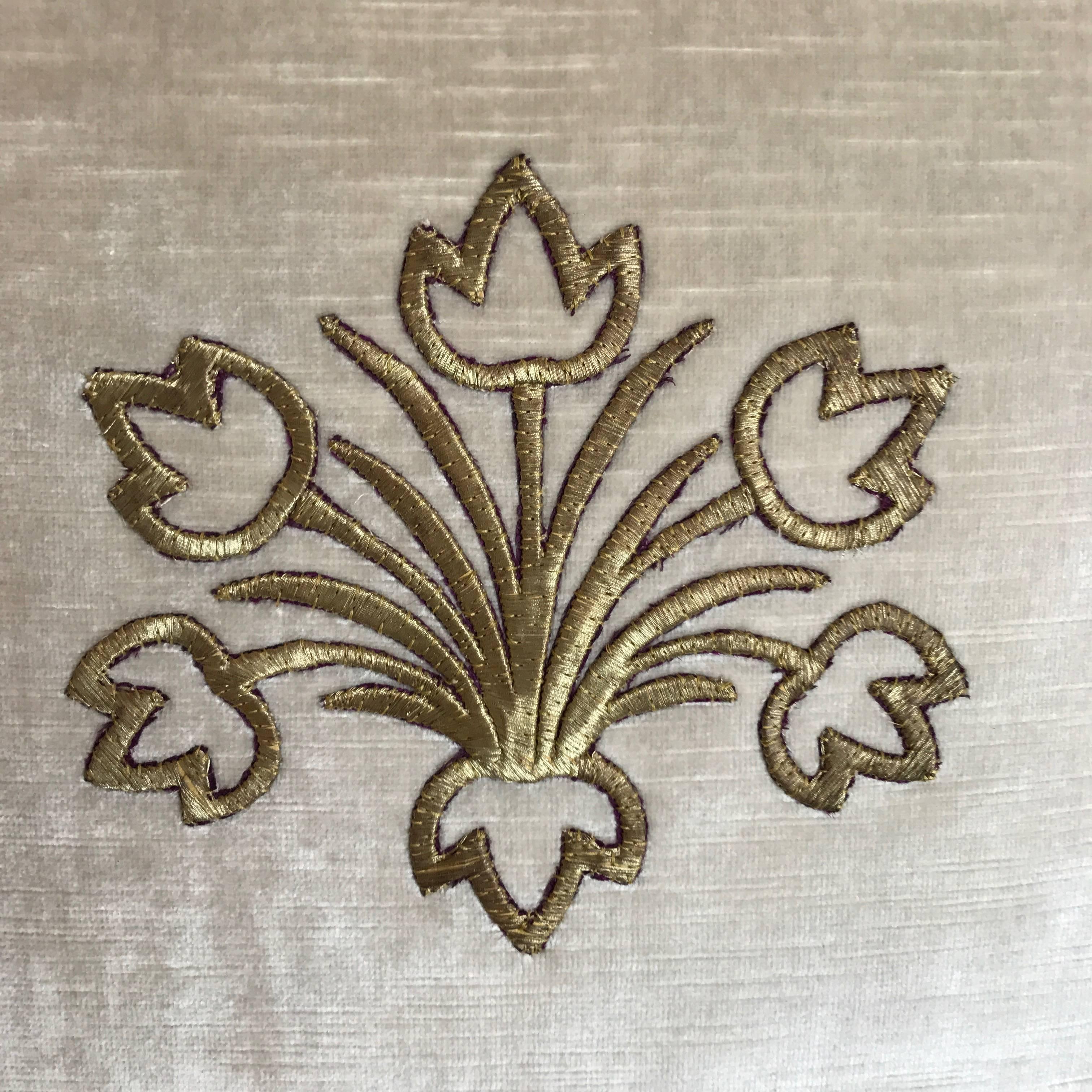 Antique Ottoman Empire raised gold metallic embroidery of a spray of tulips framed with antique gold metallic galon on oyster velvet. Hand trimmed with vintage gold metallic cording knotted in the corners. Down filled.