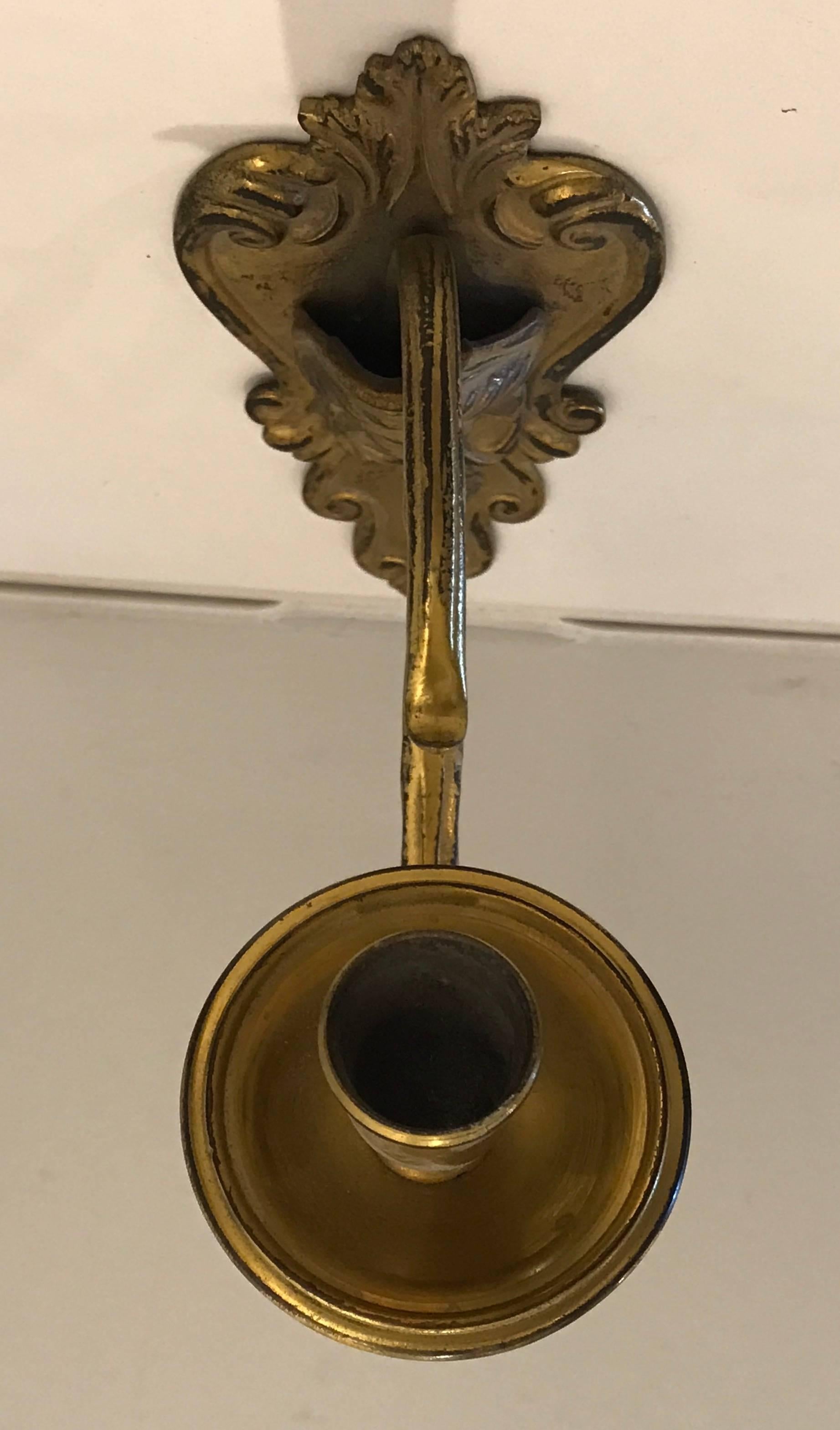 19th century gilt bronze candle sconce with face detail.