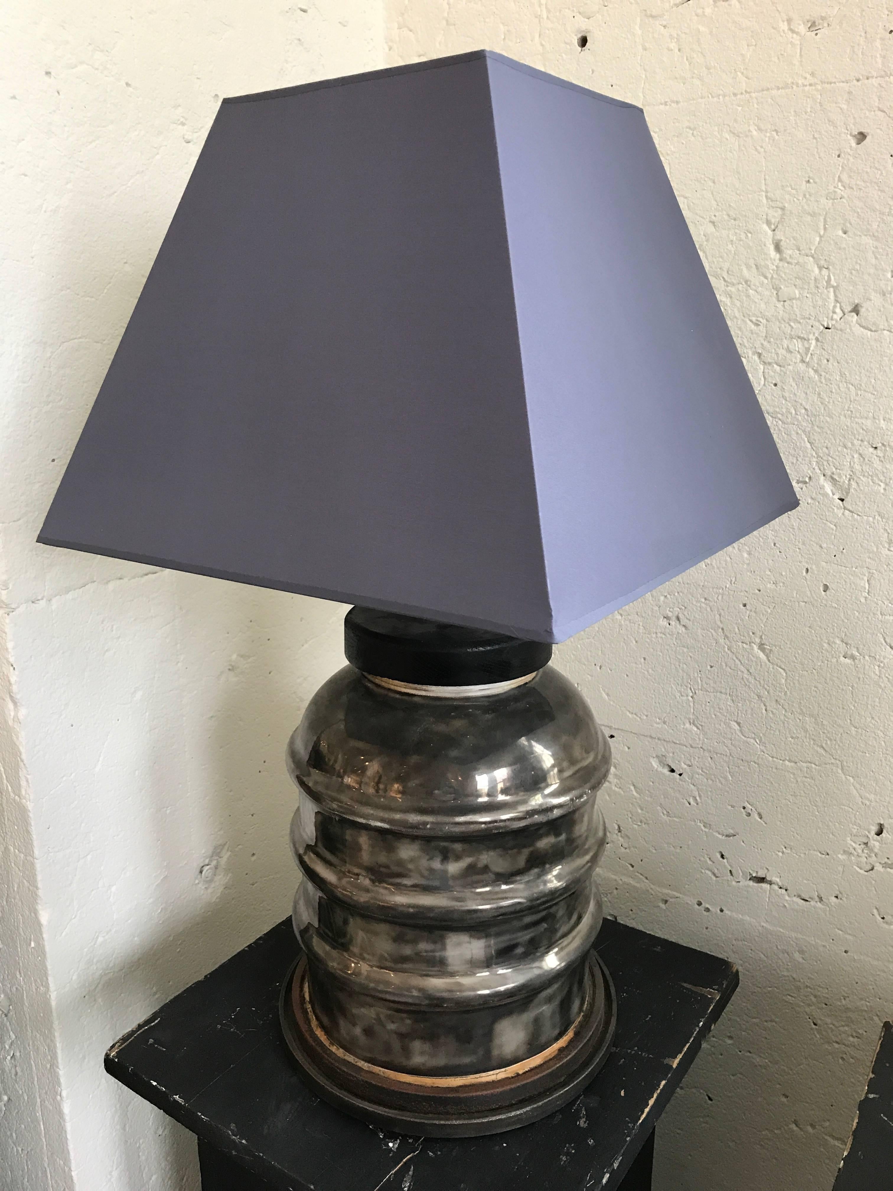 Ceramic isolant lamp with shade.