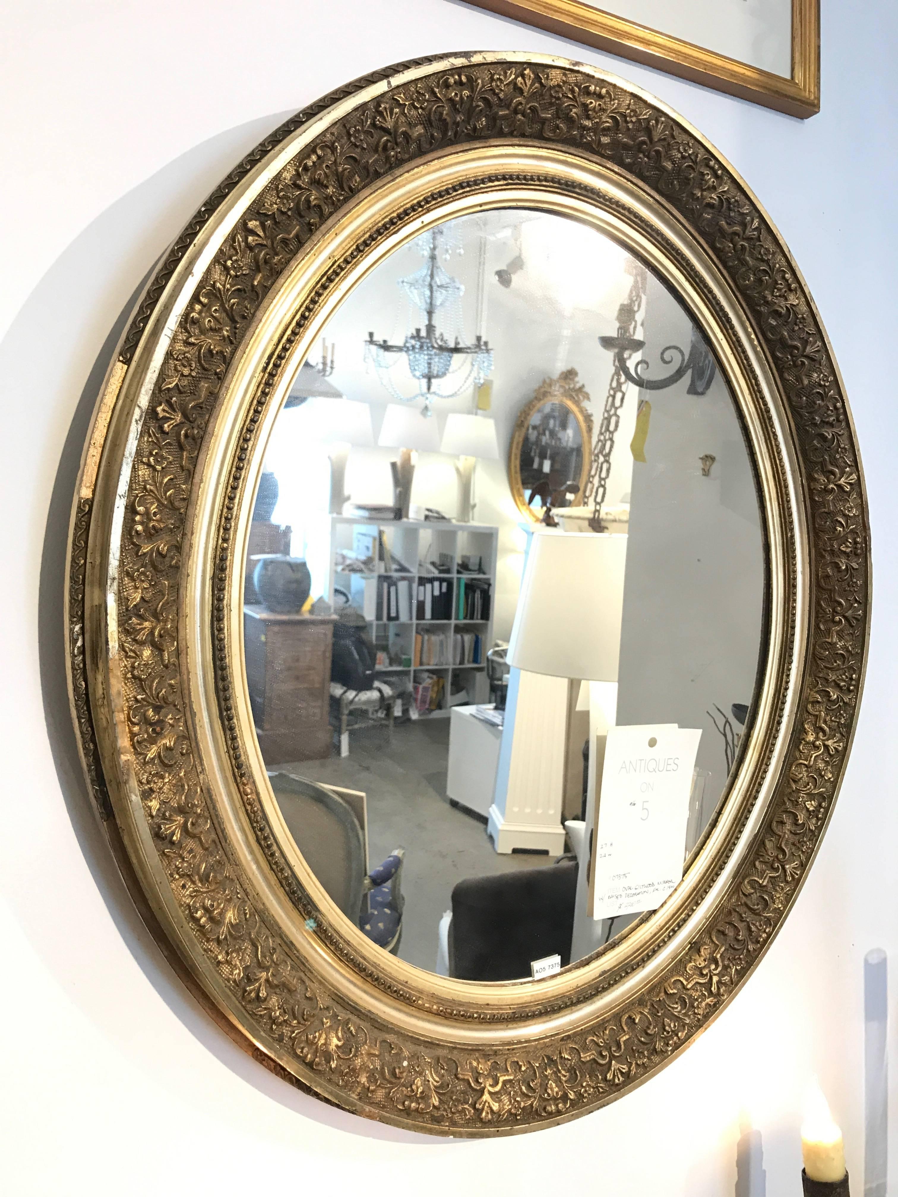 19th Century French Gilded Mirror with raised decorations.