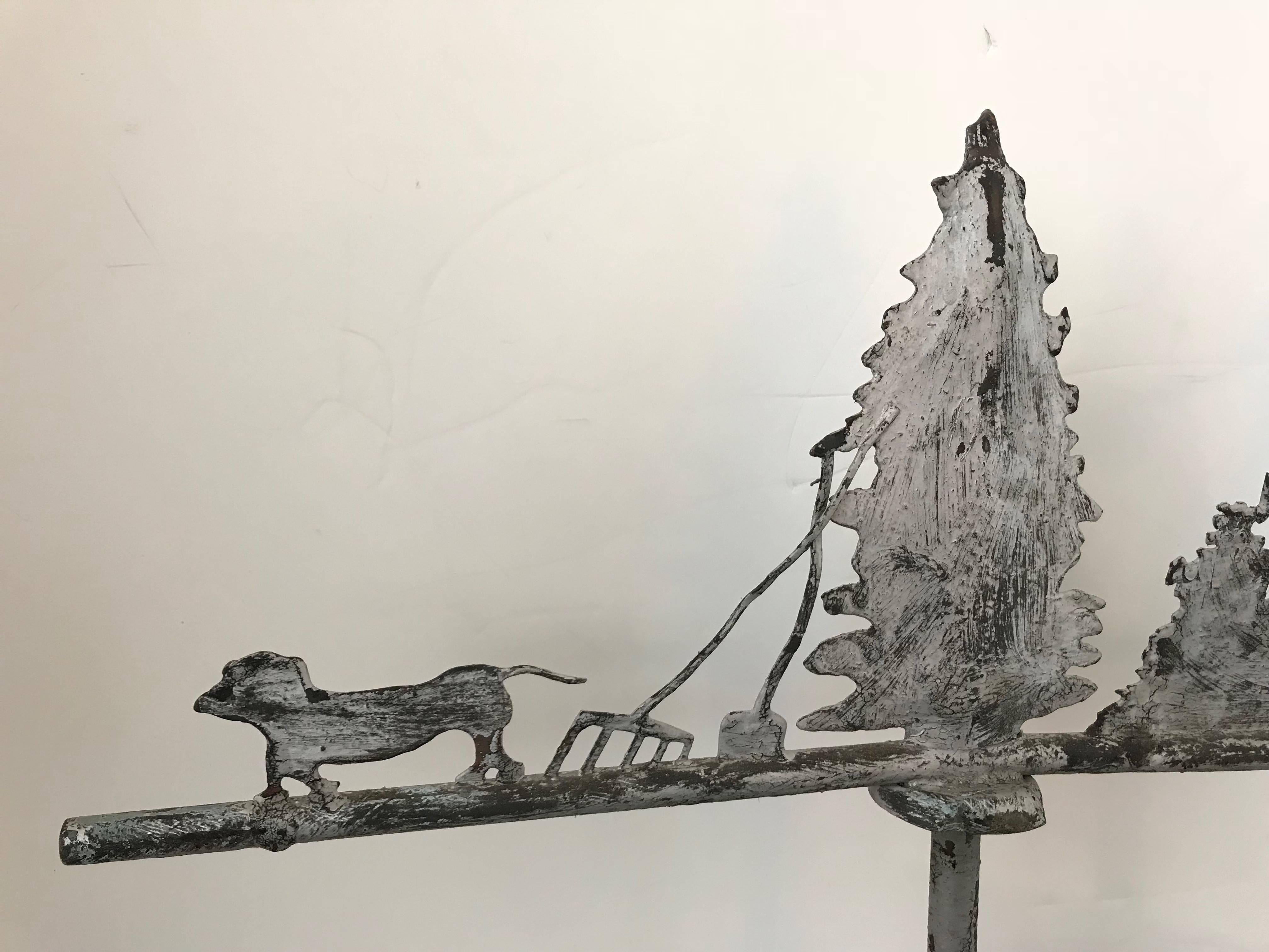 Zinc weathervane with woman, dog and farm tools.
    
