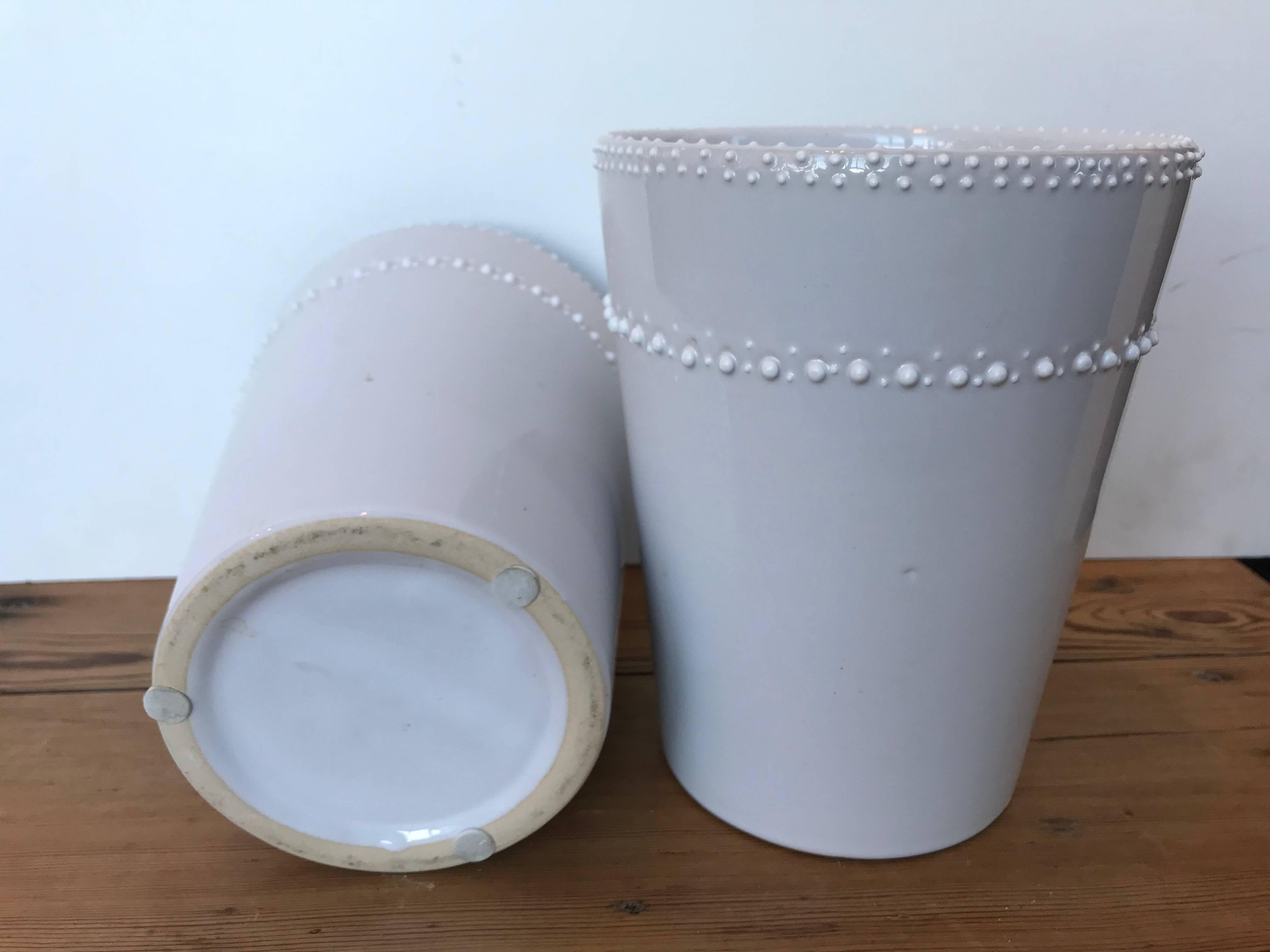 Two white ceramic vases/cachepots.