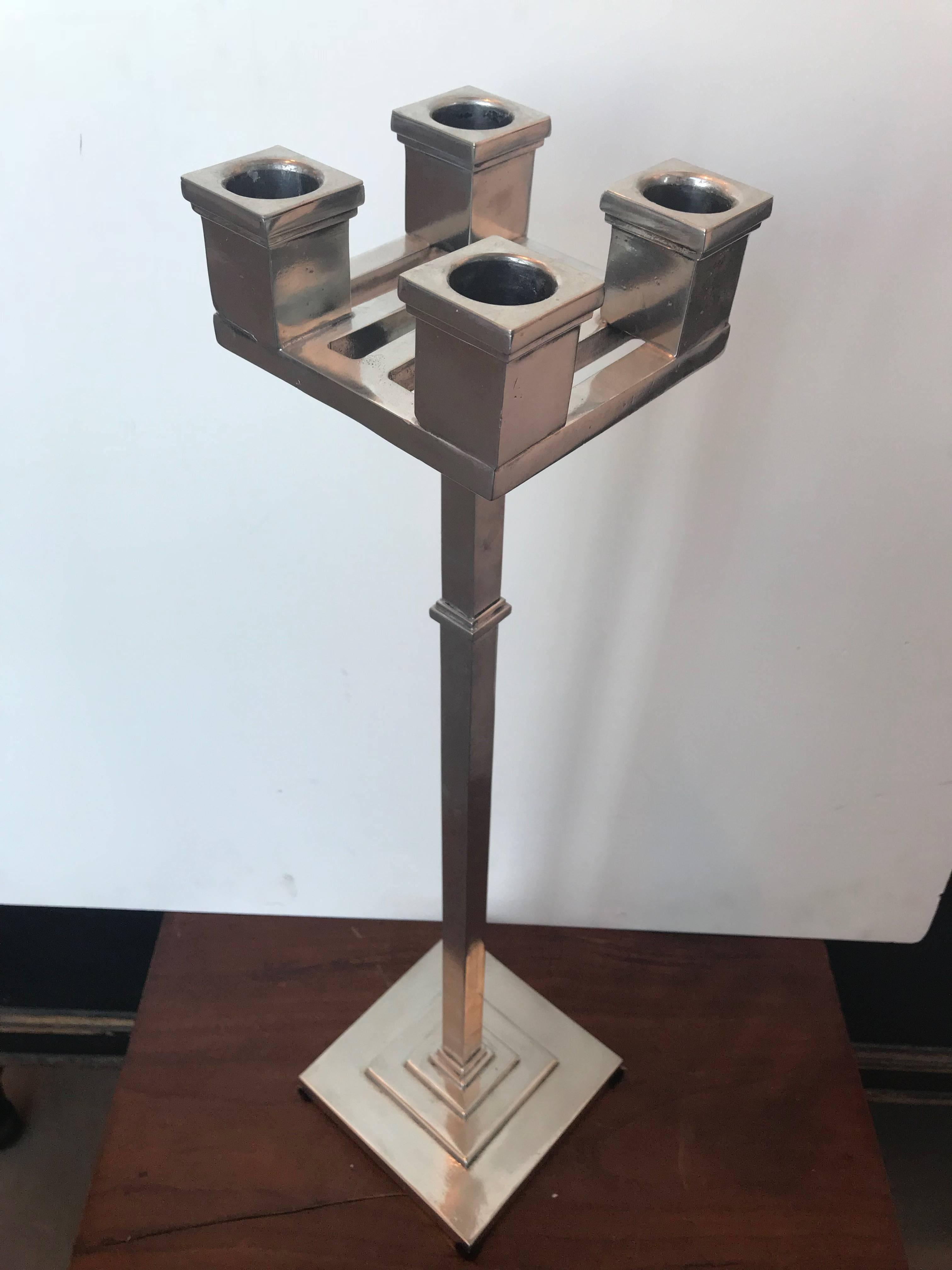 Four-slot pewter candelabra with square base.