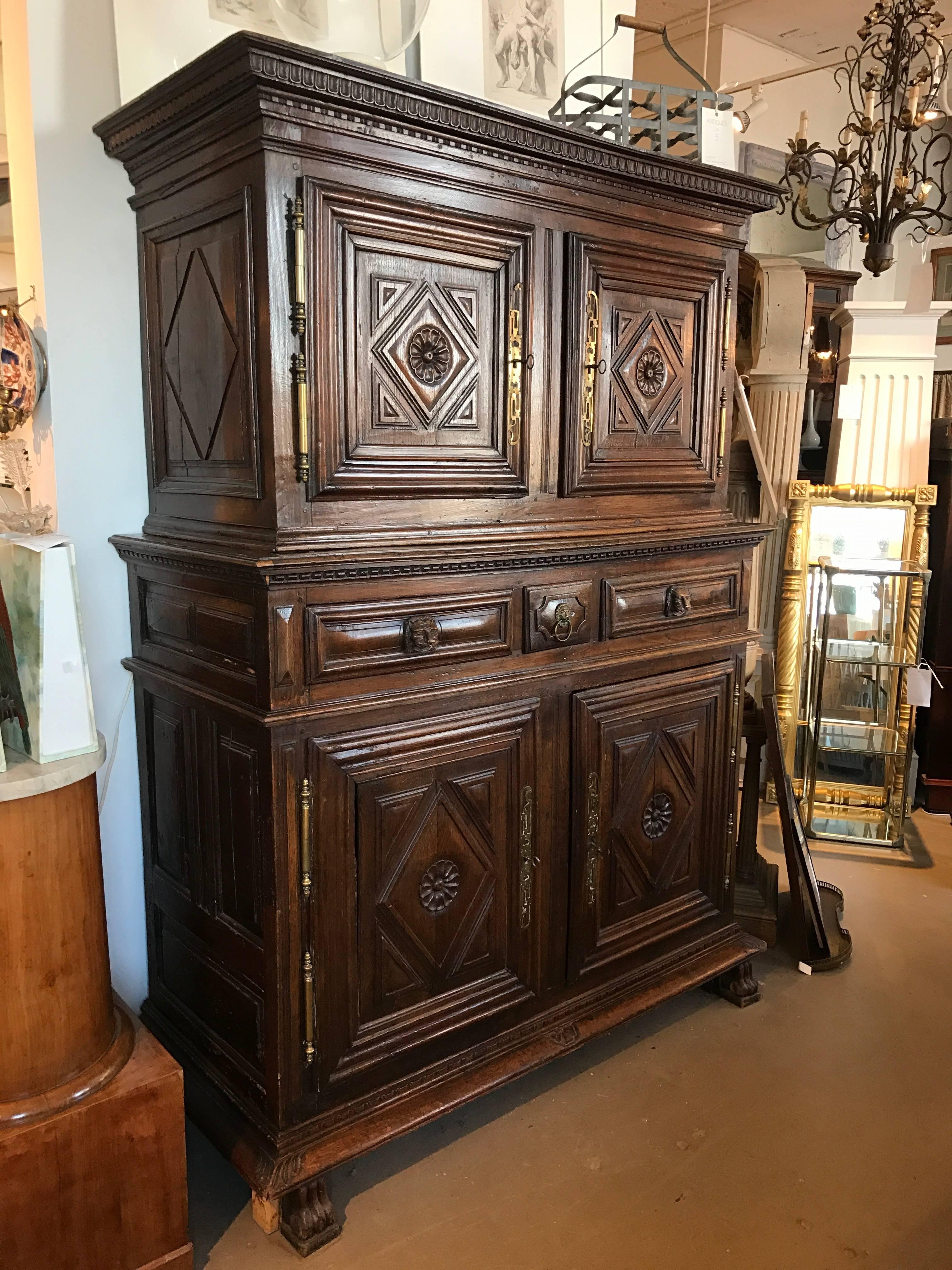 An exceptional Louis XIII chest on chest with four doors and three drawers highly carved with dental molding, paw feet and retaining its original finish.